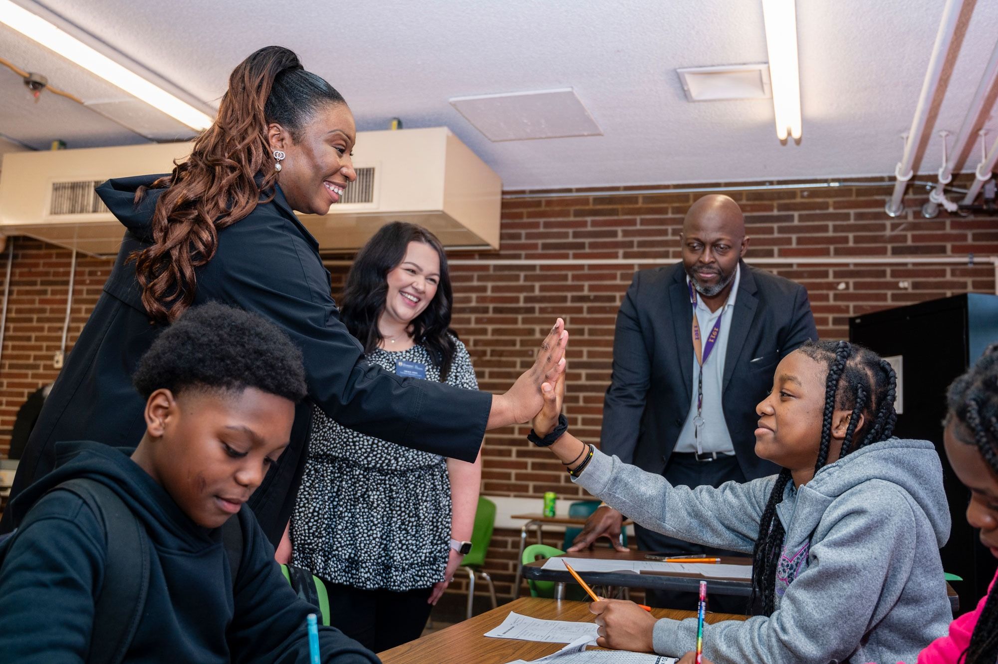 Tutor high-fiving a student