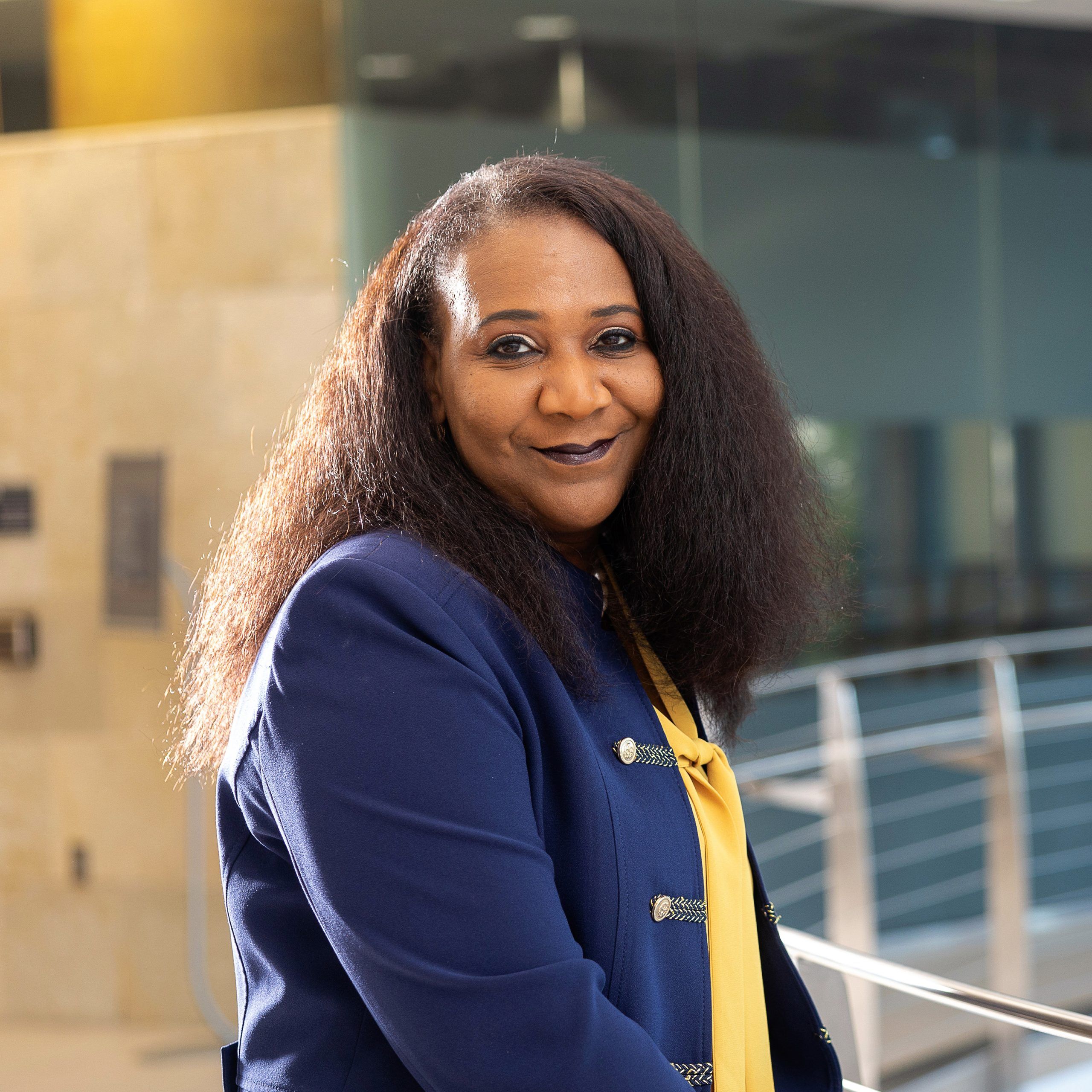 Headshot of Vice Chancellor of Research and Engagement, Sherine Obare wearing blue blazer and yellow blouse.
