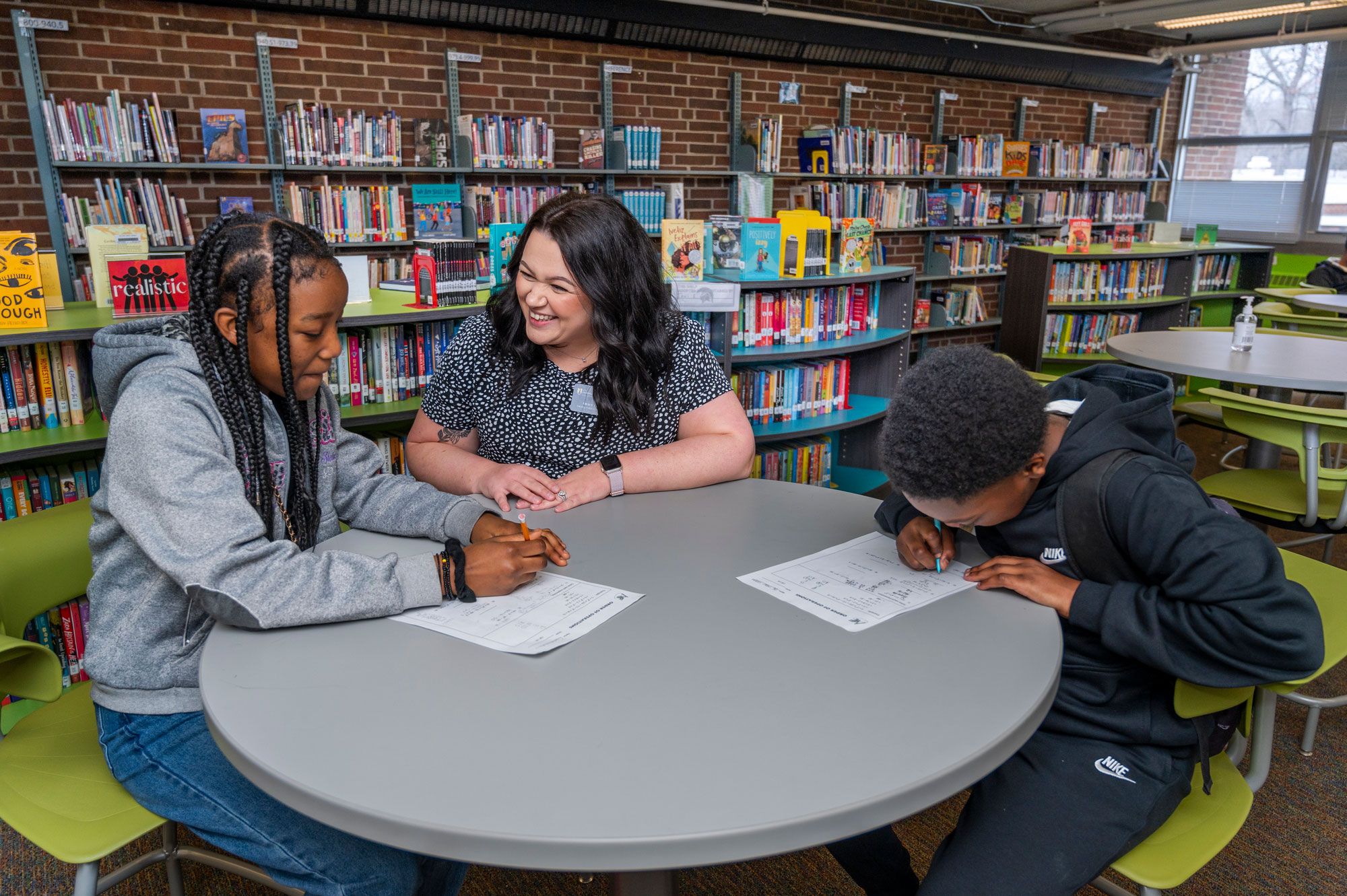 A grad student tutoring two elementary age children