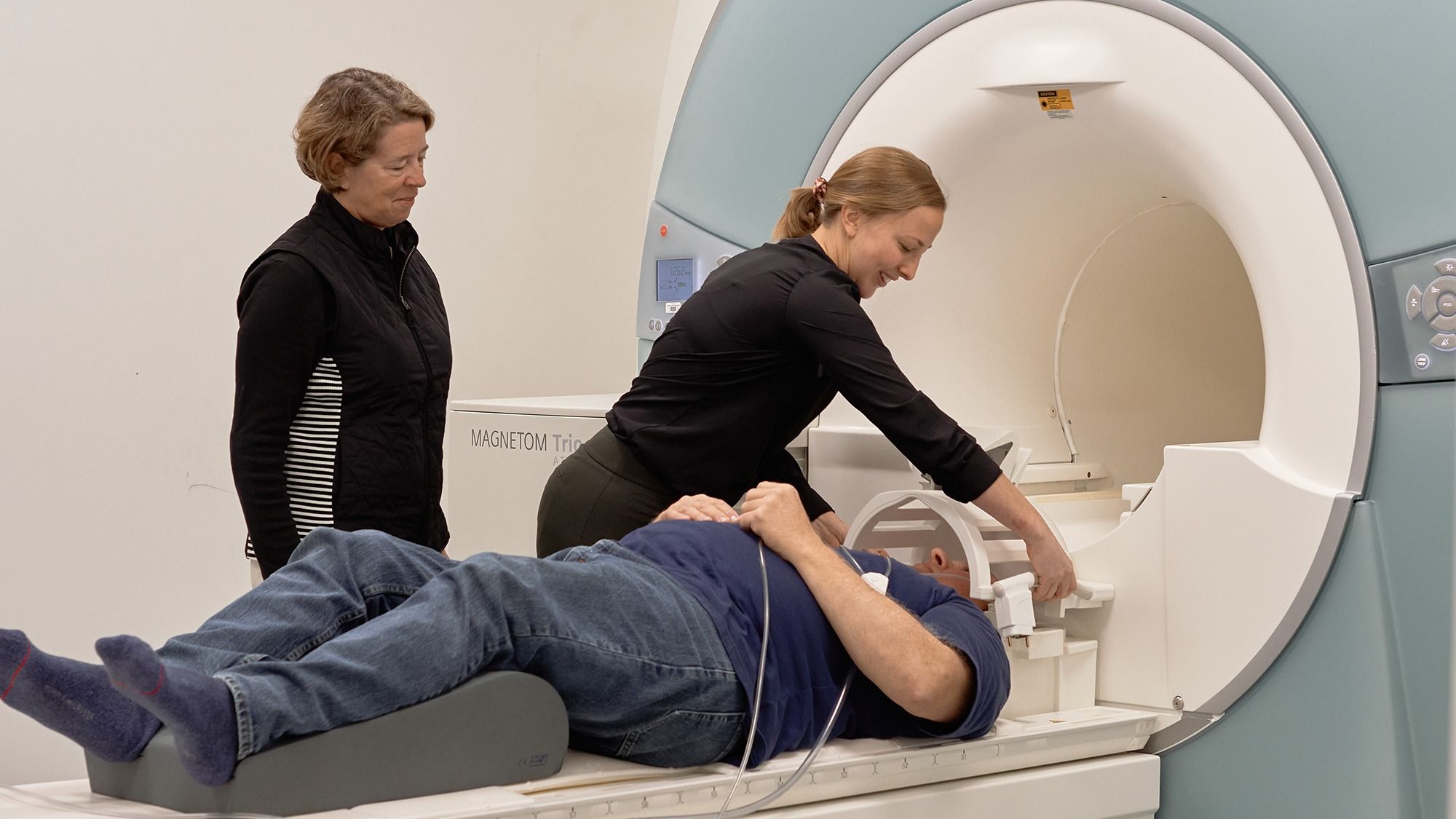 Dr. Etnier and a grad student prepare a participant for an MRI scan.
