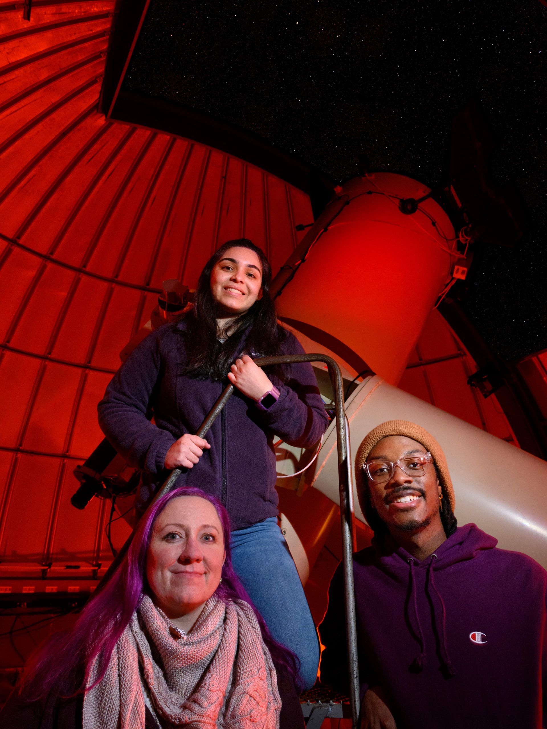 Dr. Aarnio, Mariann Juarez, and Kamara Culbreath standing in front of the telescope at the Three College Observatory