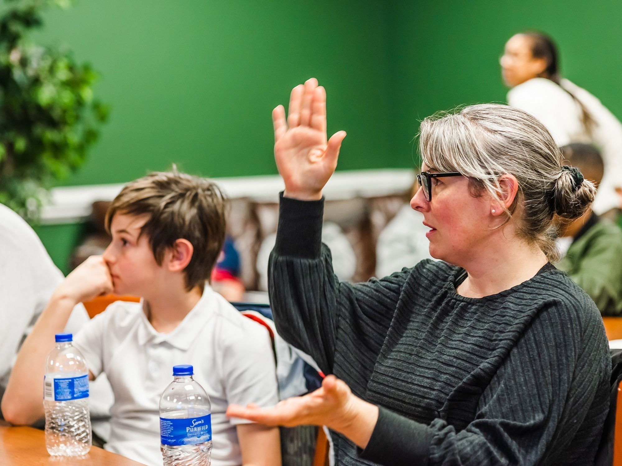 Another woman and her son attend a focus group meeting.