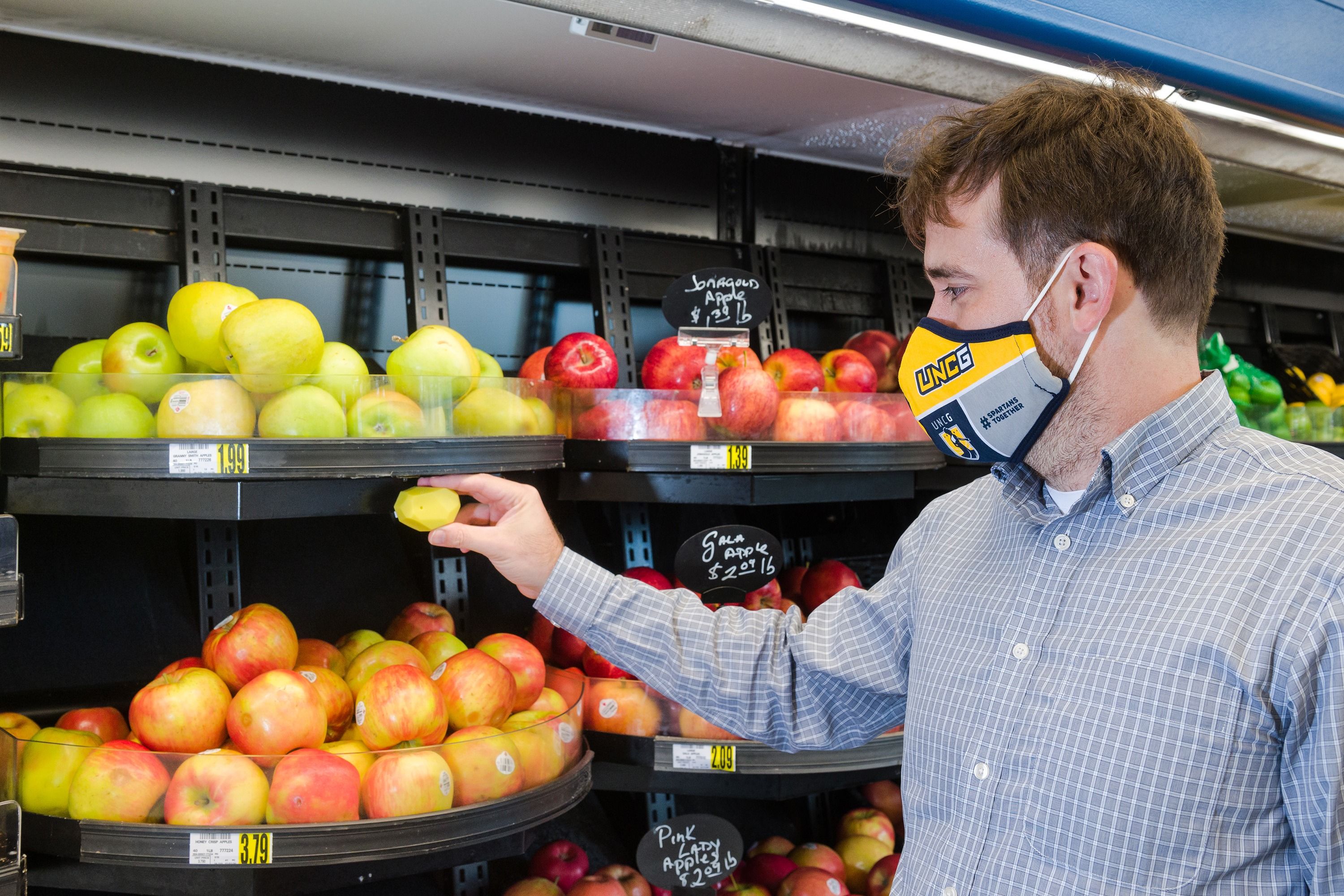 McGuirt looking at a selection of apples