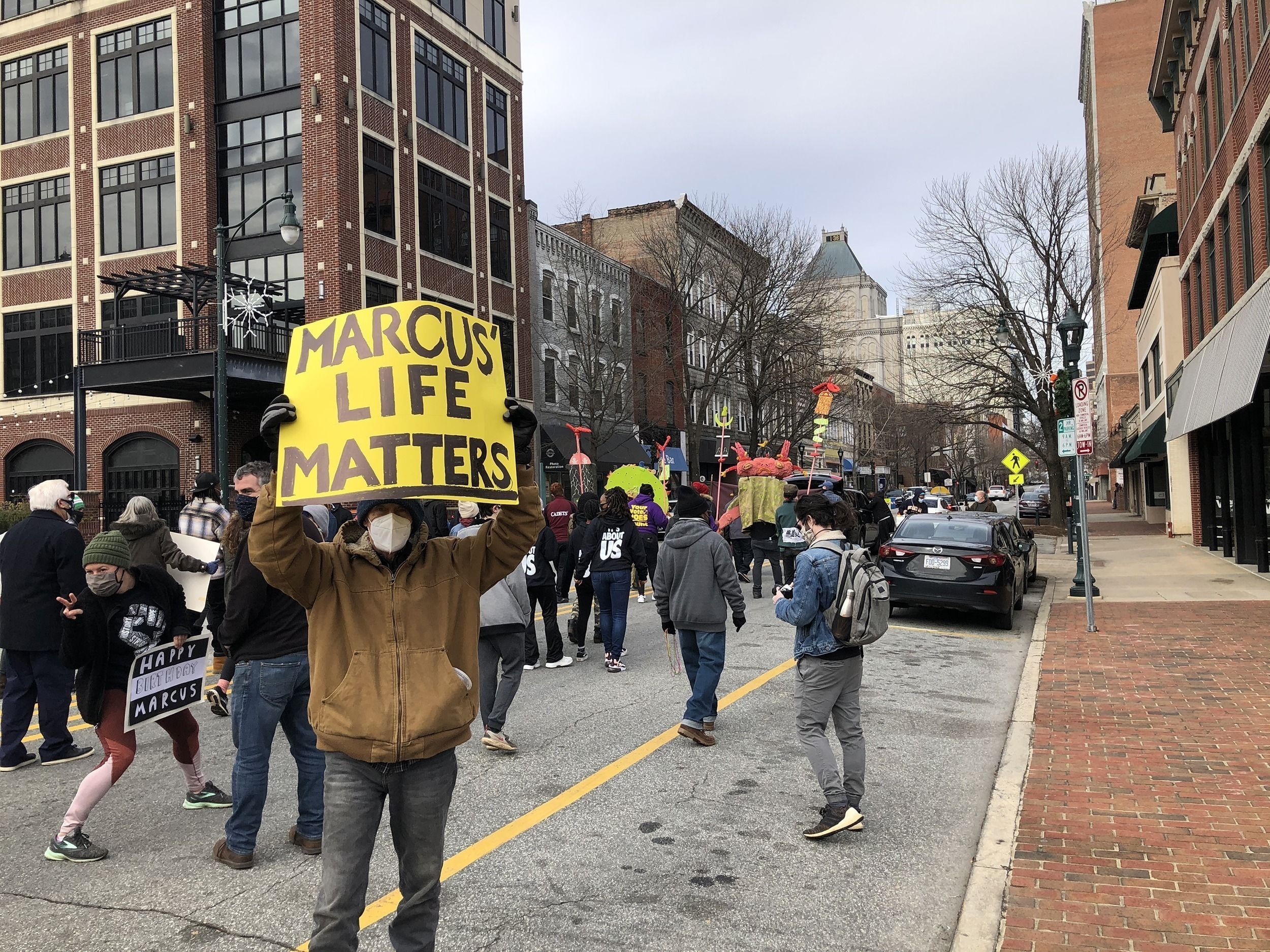 A crowd walks down the street during a protest in Greensboro.