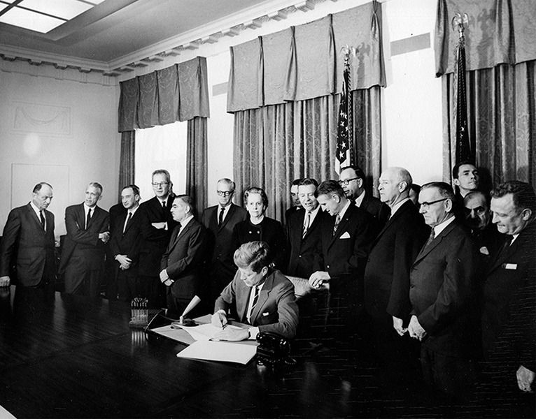 Image in White Hose as president Kennedy signs bill