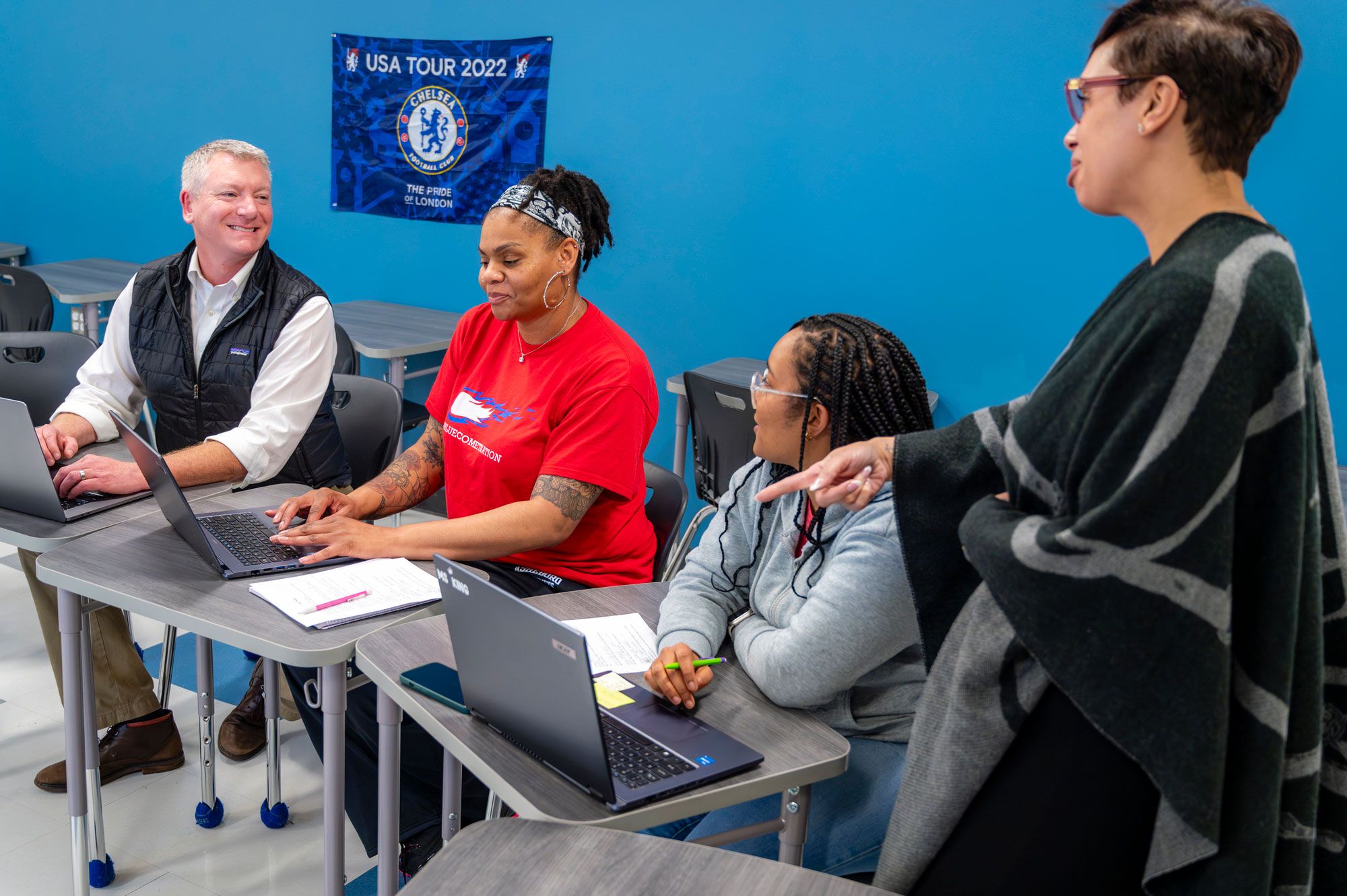 Coker pointing a student's work on laptop