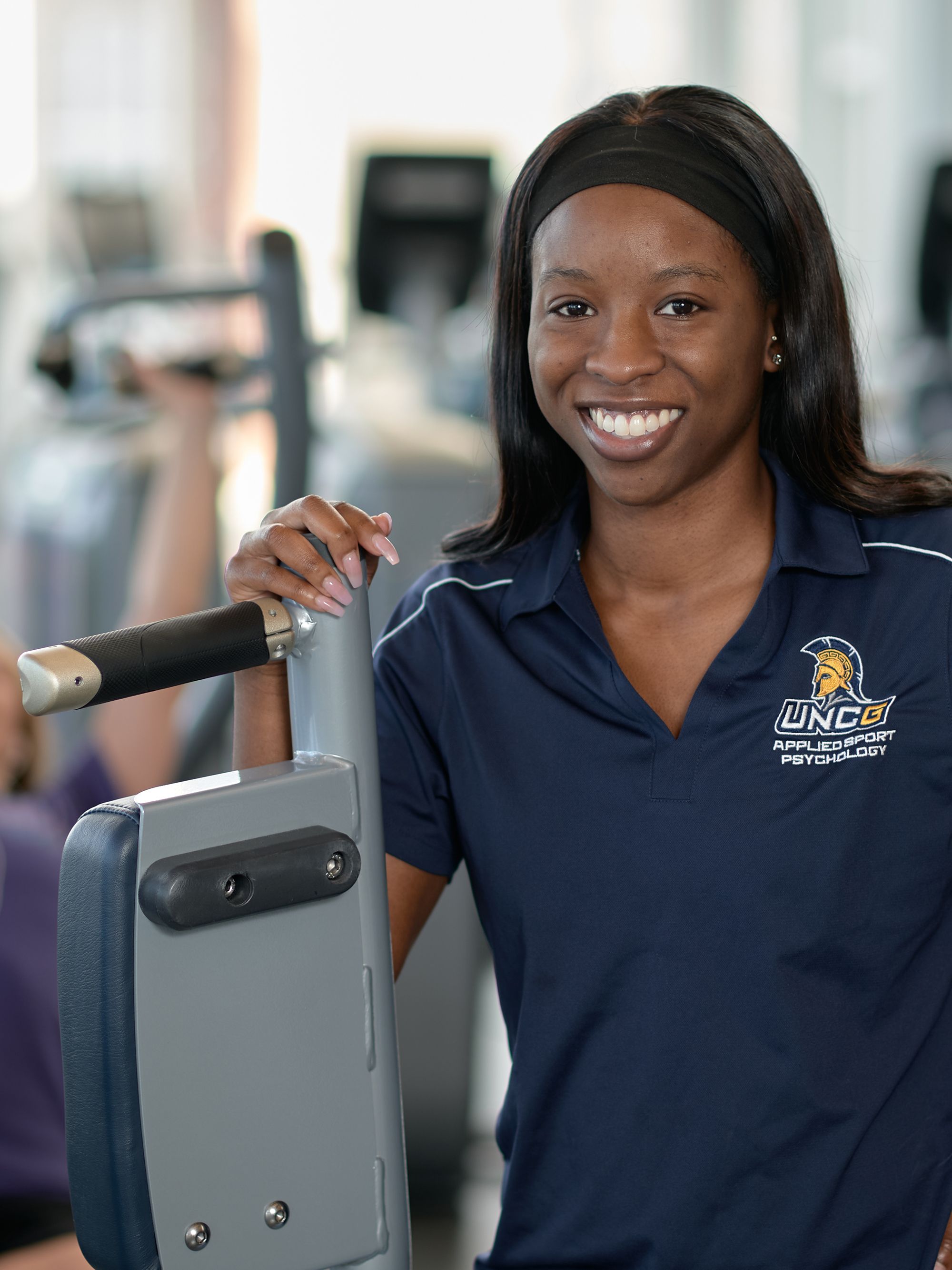 Applied sports psychology grad student Alexis Rice standing in the Kaplan Center gym. 