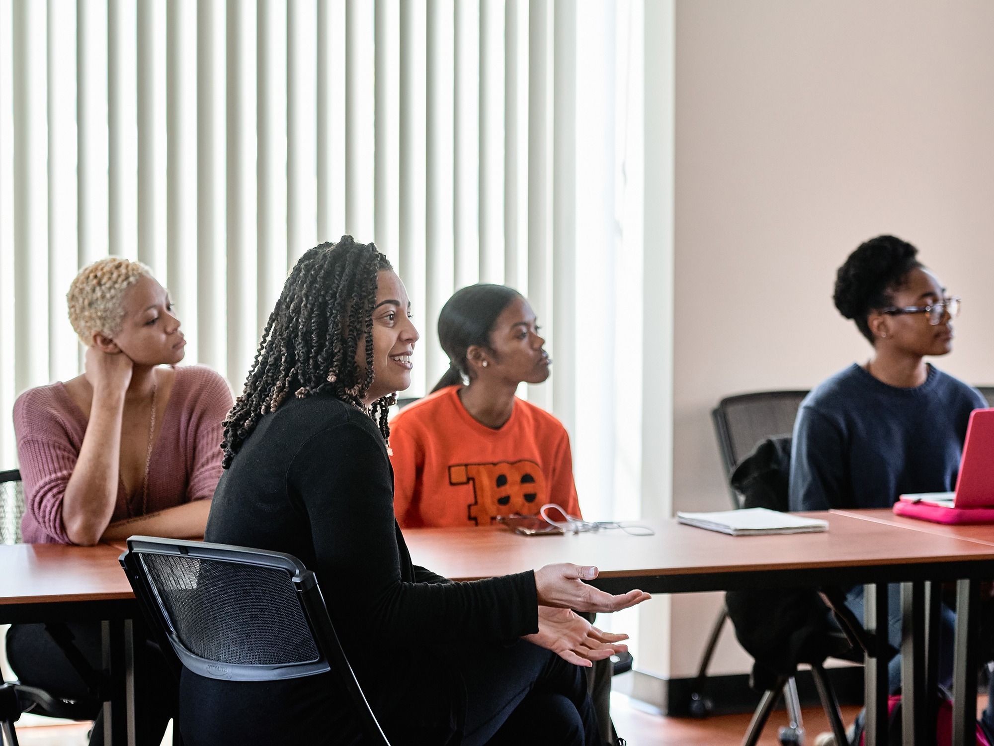 A small group of students and faculty listen to presentations at a MARC U-STAR cohort meeting.