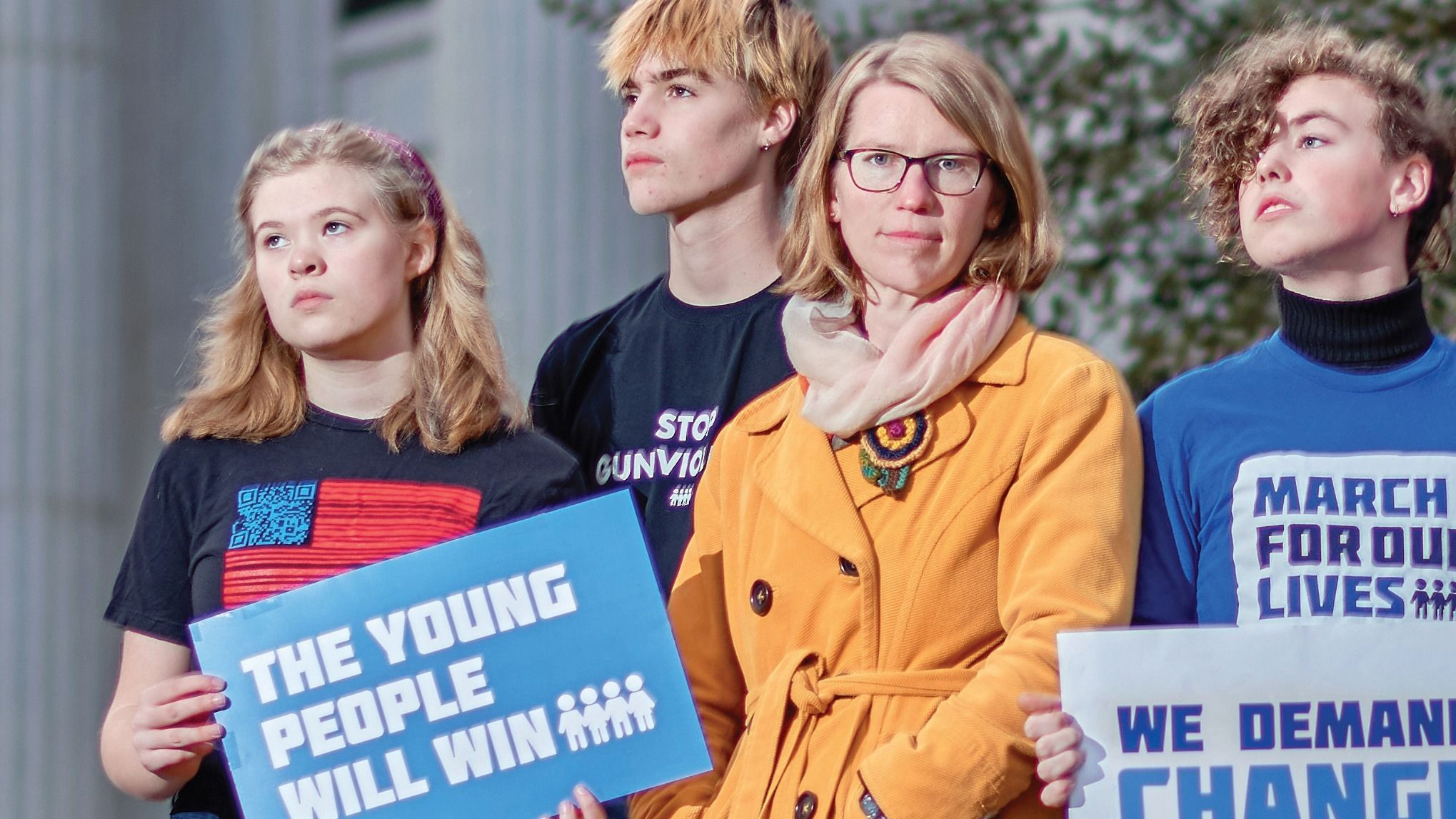 Dr. Applegarth standing with a group of youth activists holding signs.