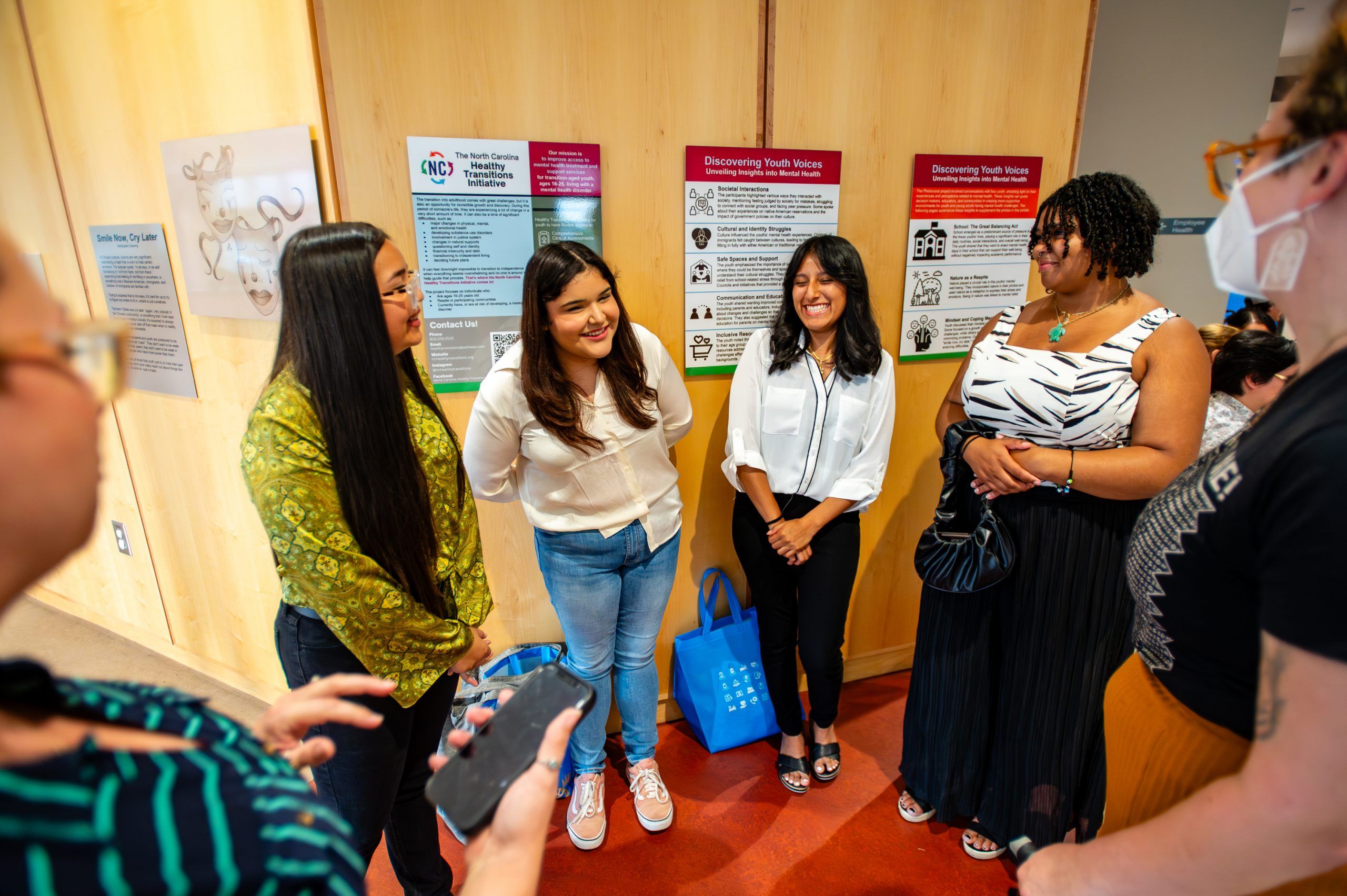 Students talking about their work at exhibit opening