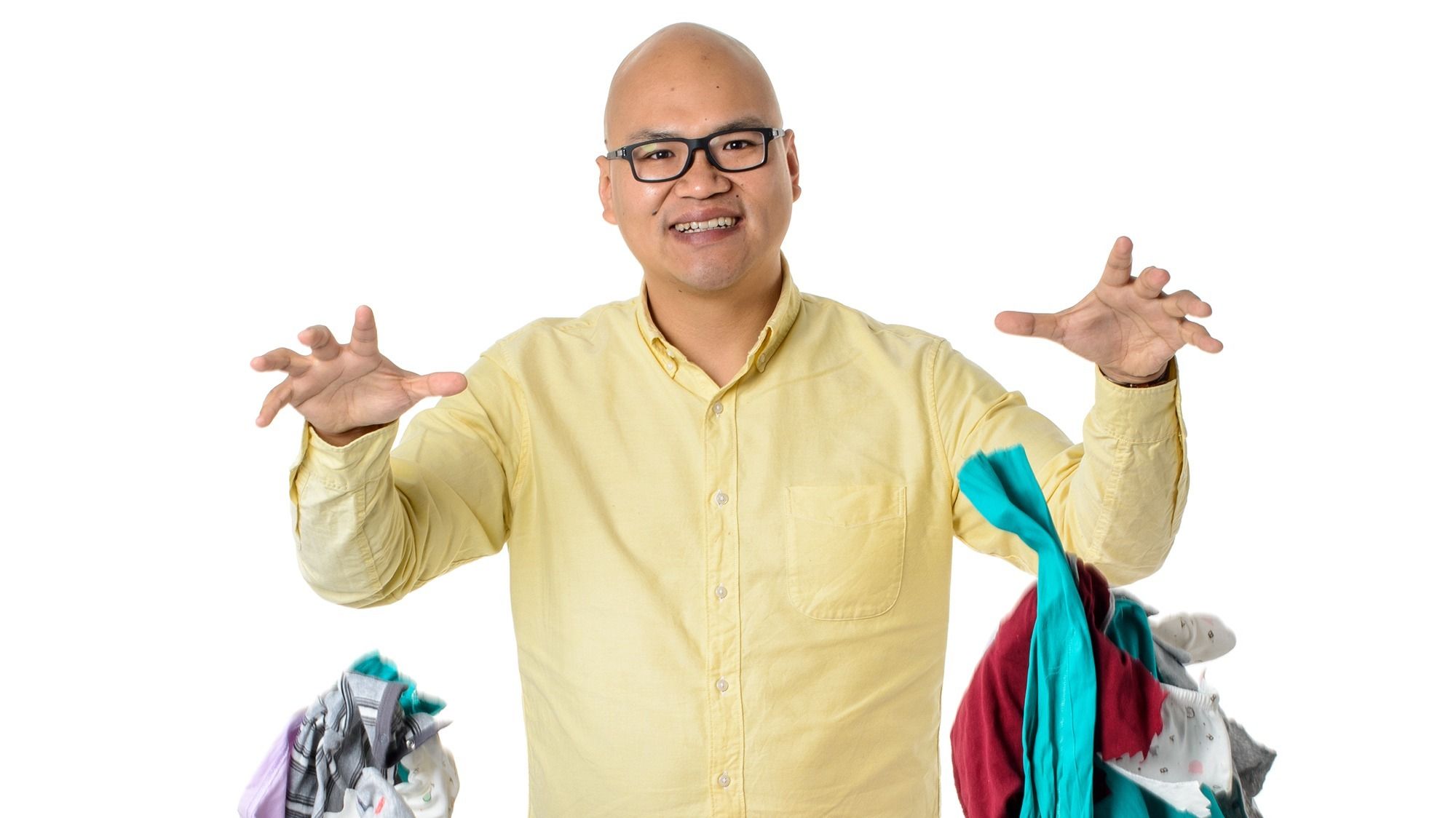 Graduate researcher Jeff Wu dropping handfuls of clothing, the focus of his research.