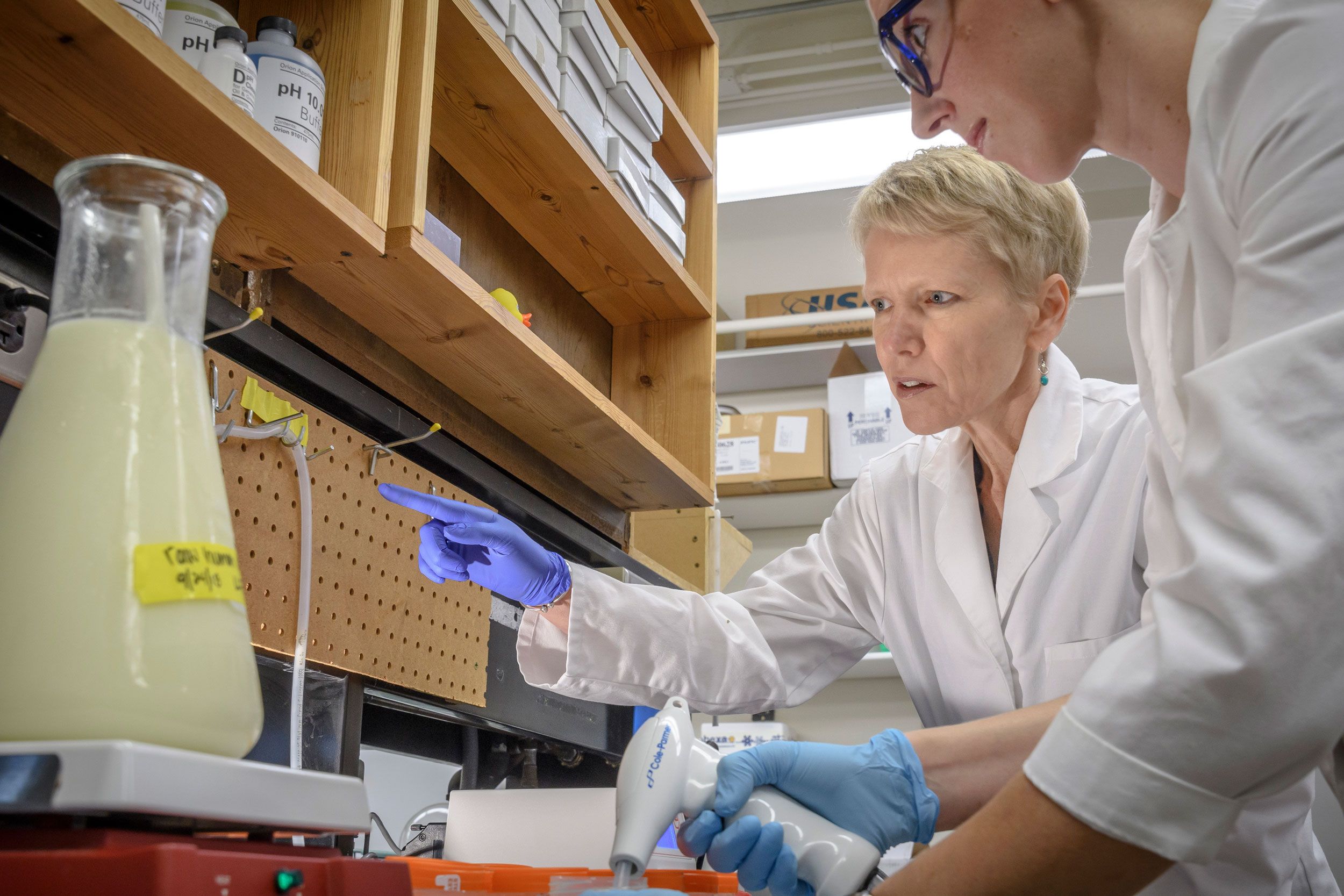 Dr. Maryanne Perrin points at a vial of donor breast milk