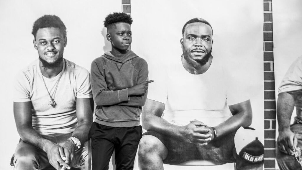 Kevin Oliver jr's son next to one of Dr. Lee's works