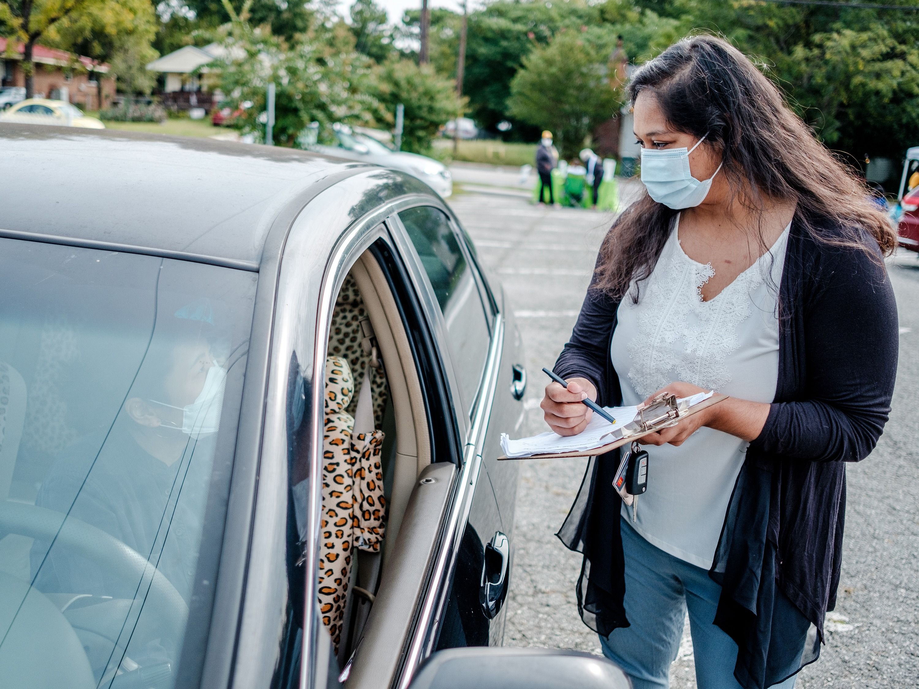 Xiadani Avila collecting data carside
