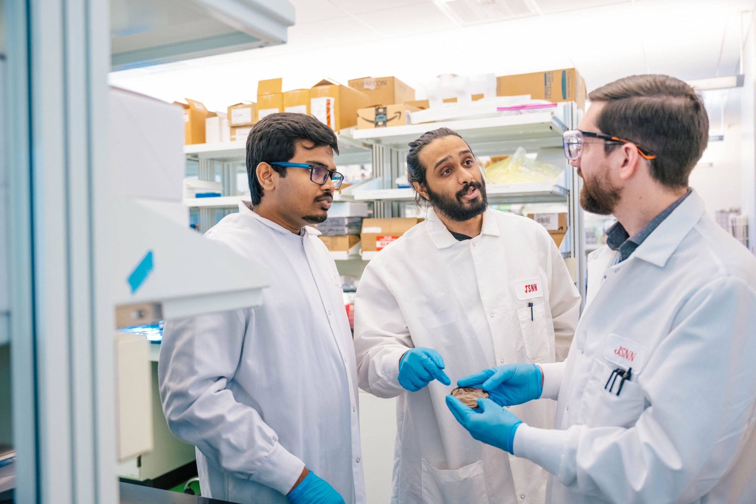 Wideman next to the Bod Pod, a machine that takes measurements of a child's body