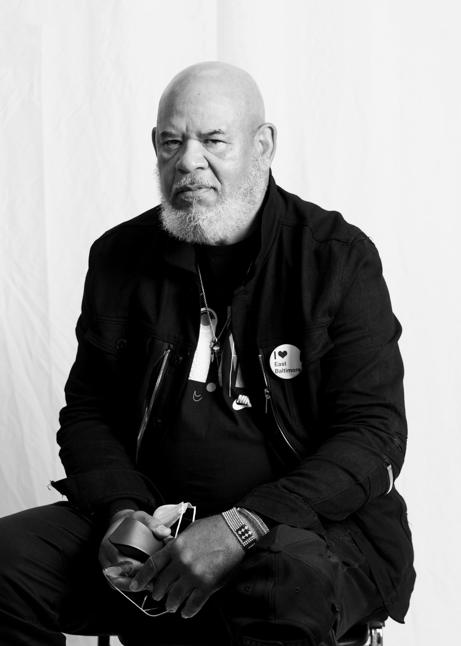 A black and white photo of a Black man wearing a jacket. 