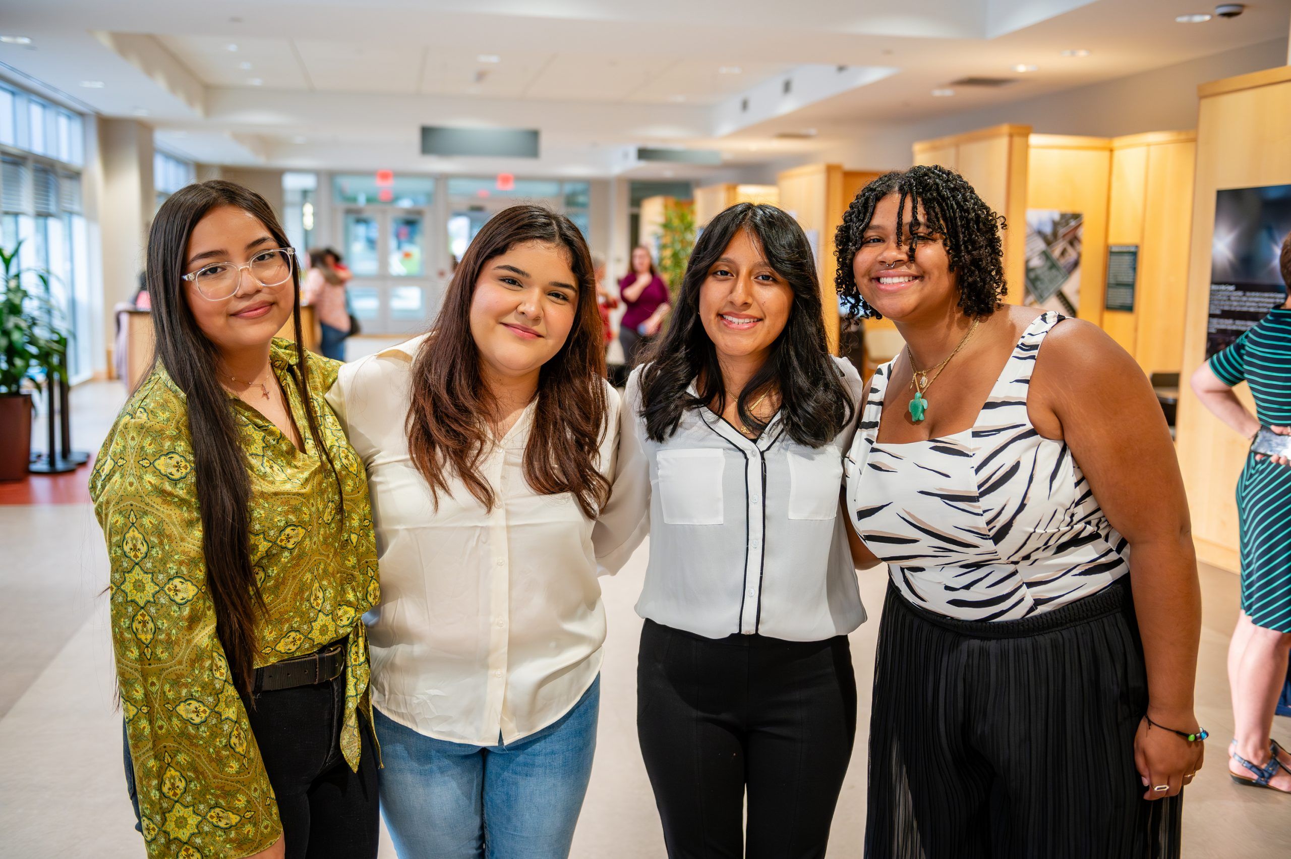 Four participating teens pose at the exhibit opening