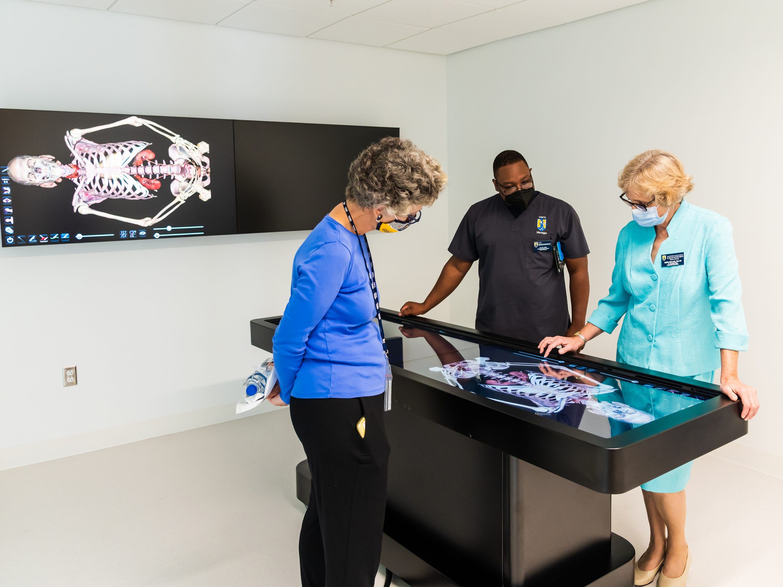 Three people explore the virtual human body