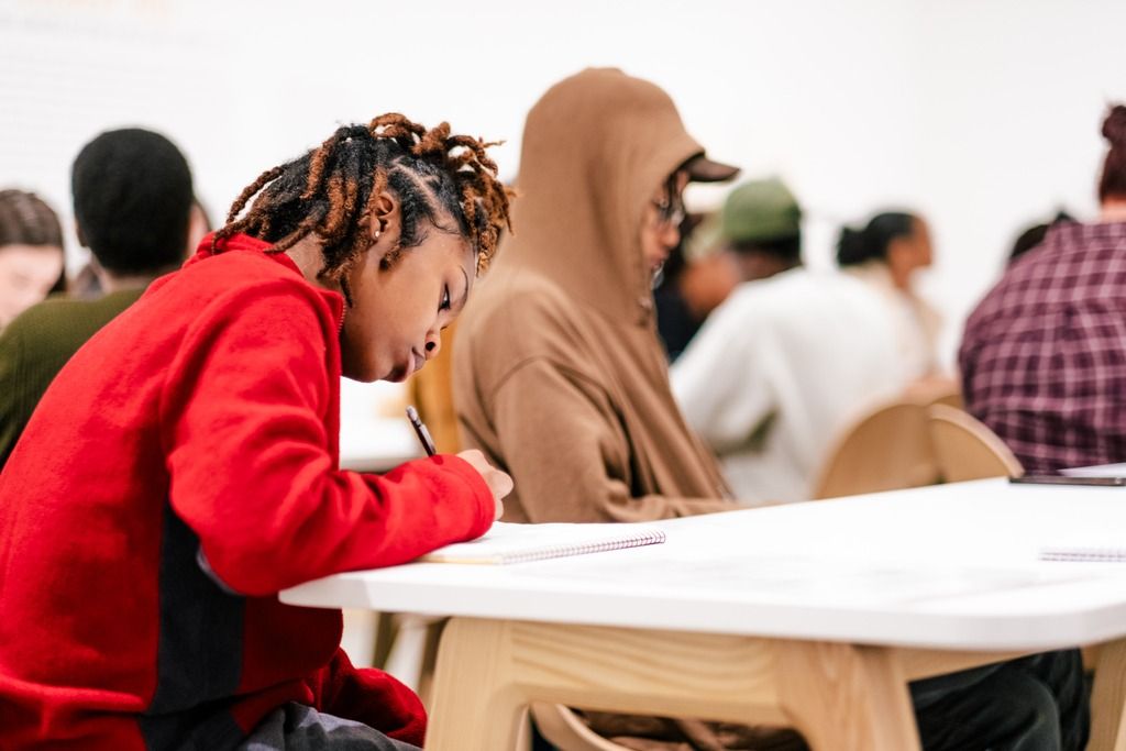 A student drawing in the Disney exhibit