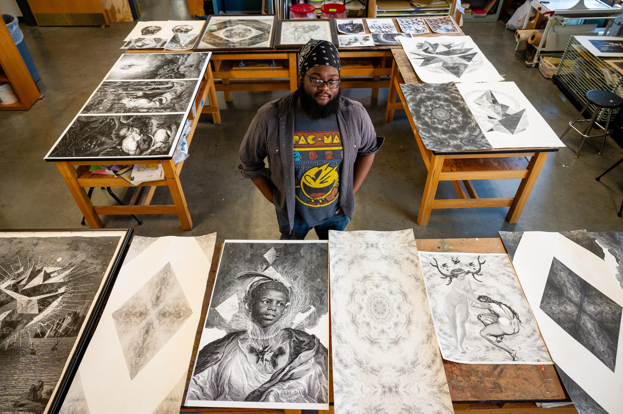 Miles-Moultries poses with a collection of prints