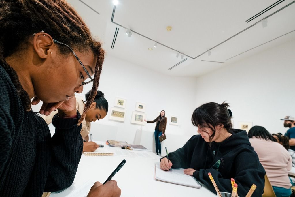 Students using early Disney animations cels to study animation