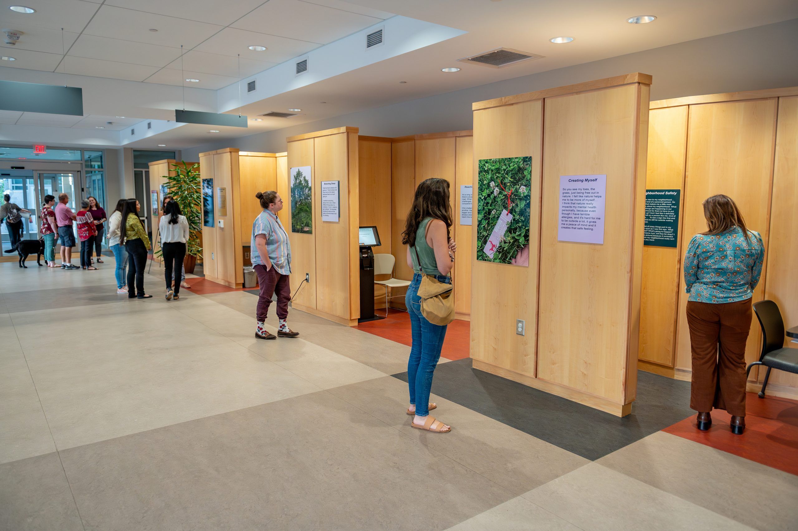 Viewers observing exhibits in the "Healthy Transitions" exhibit
