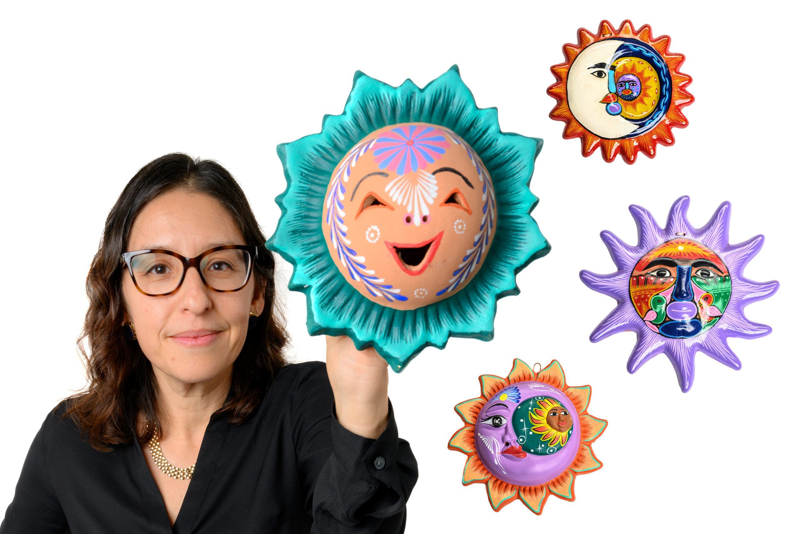 Dr. Stein holding up one of the folk art suns from her collection.