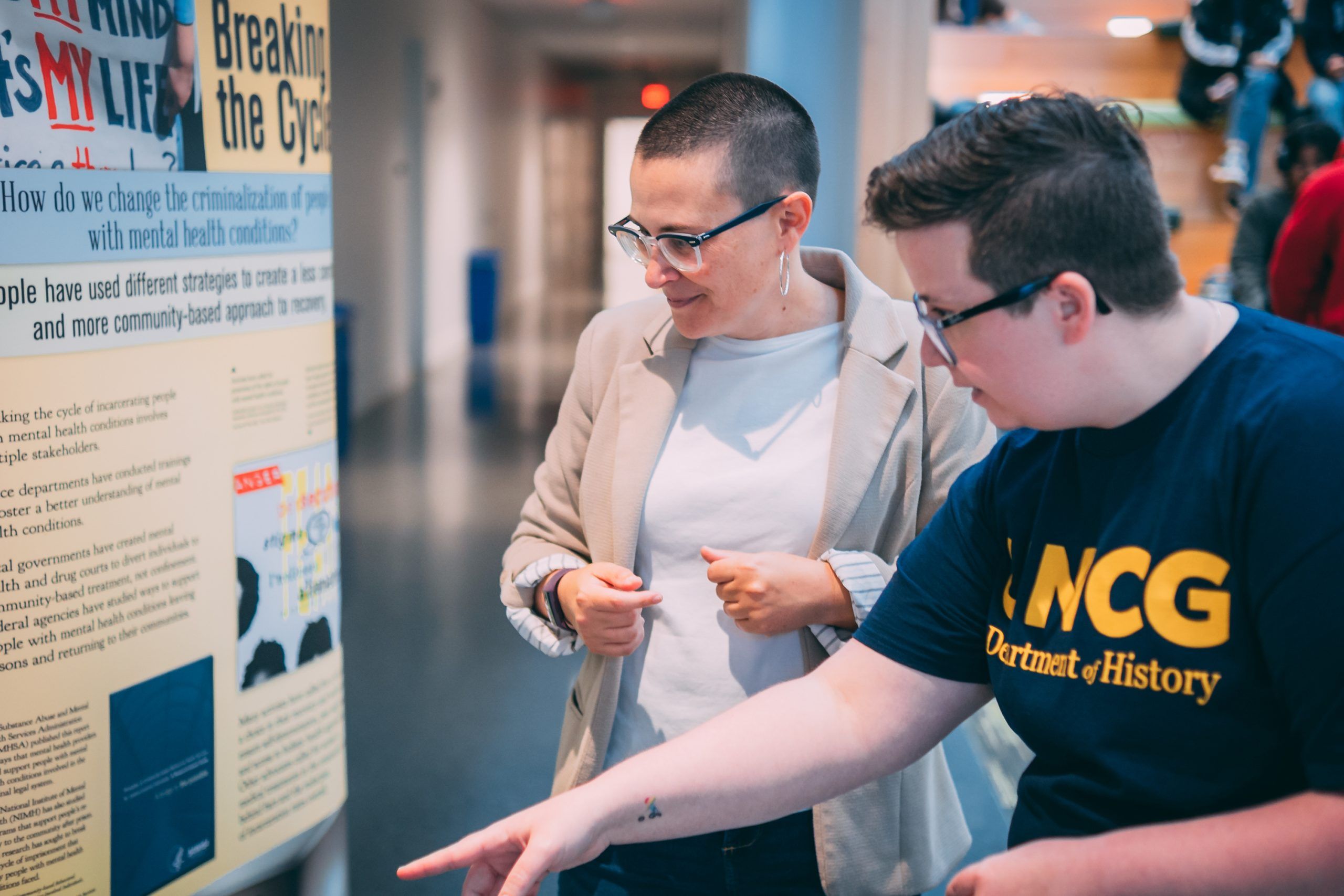 Parsons and UNCG student look at the display