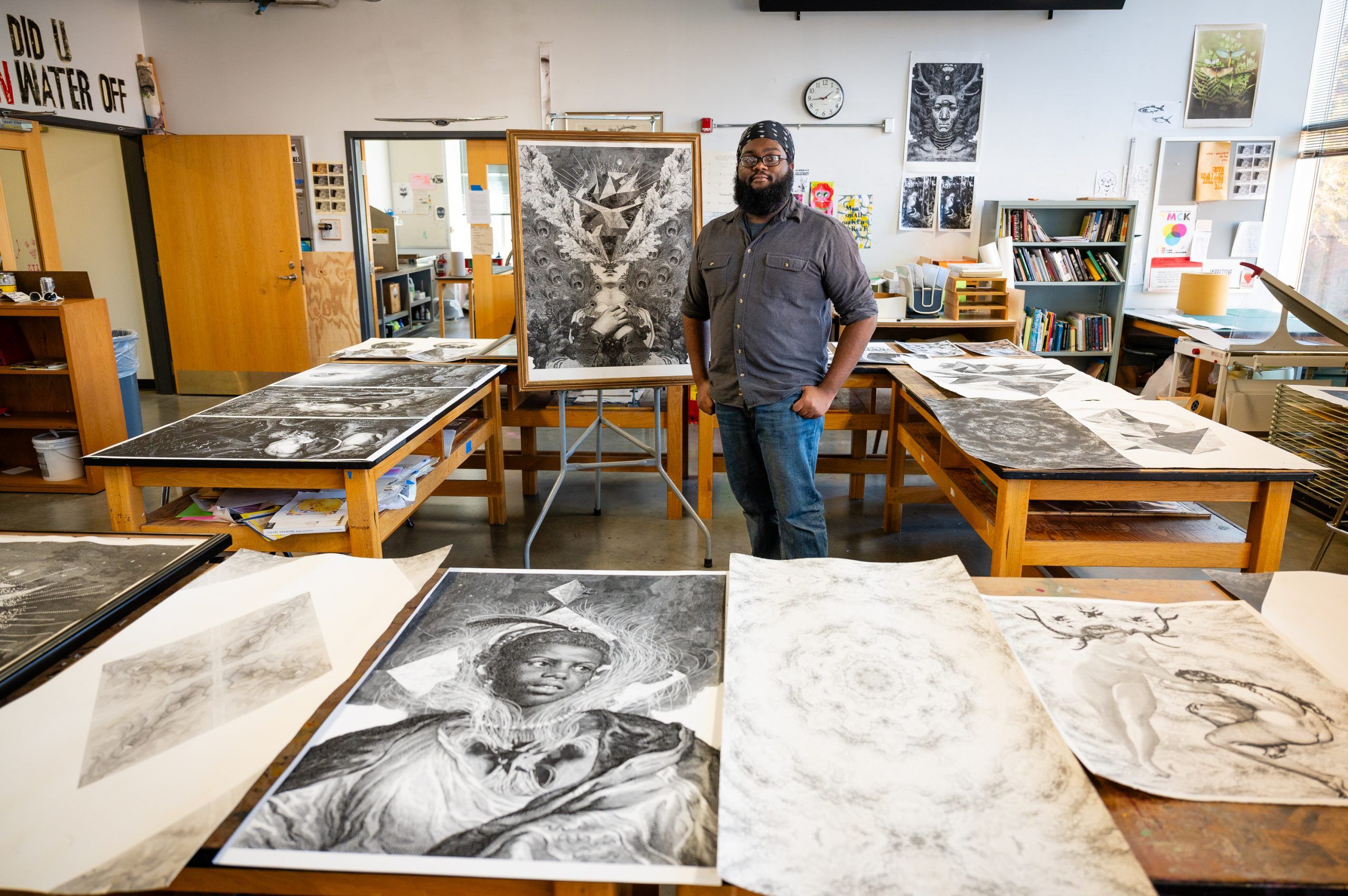 Miles-Moultrie poses with his prints in the studio