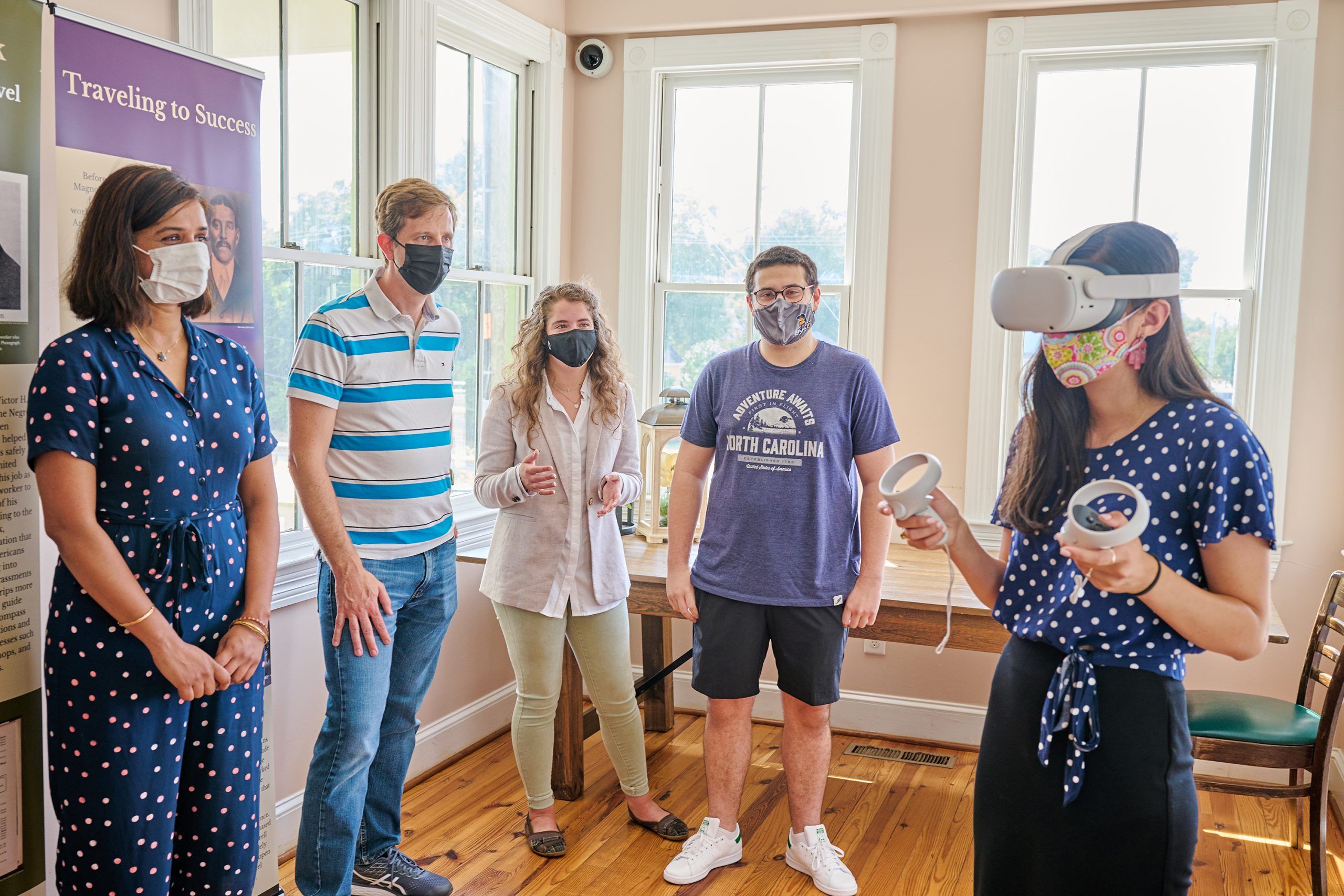 Melissa Knapp tours the Magnolia House in VR, while Drs. Kopper and Kutty look on with their students.