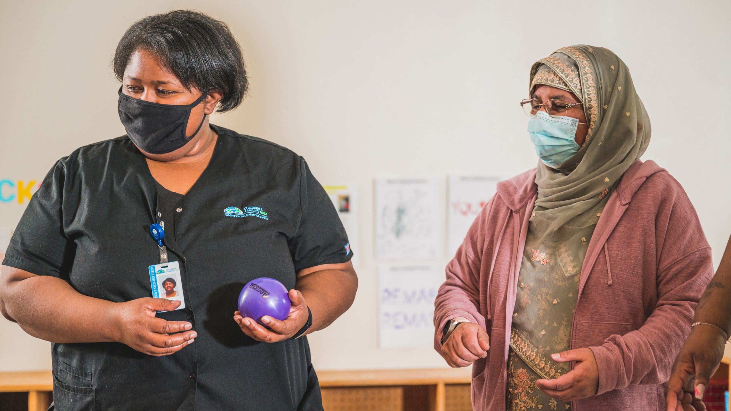 Two grad students wearing face masks. 