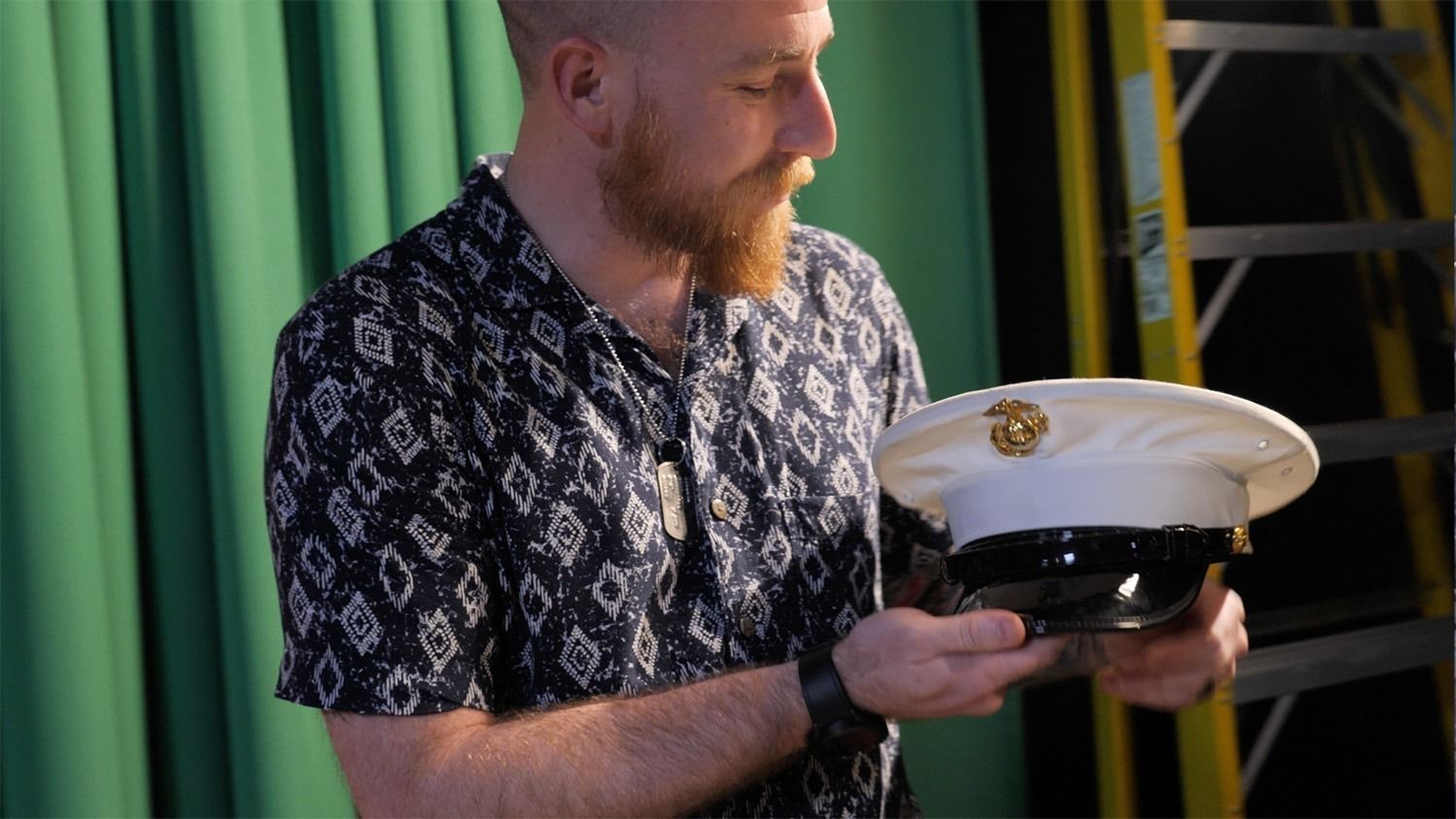 David Miller holding a marine hat
