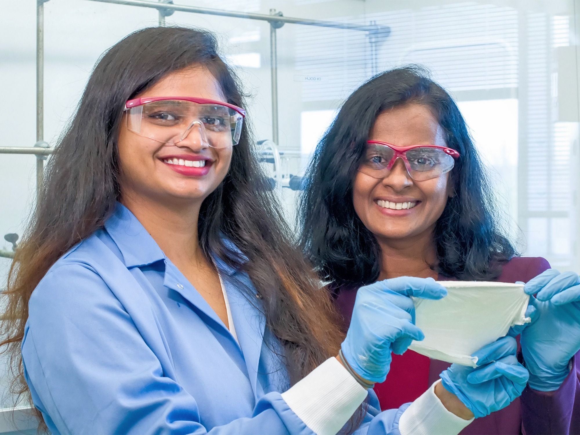 Dr. Rathnayake and grad student Sheeba Dawood hold up a nano-filter they created.