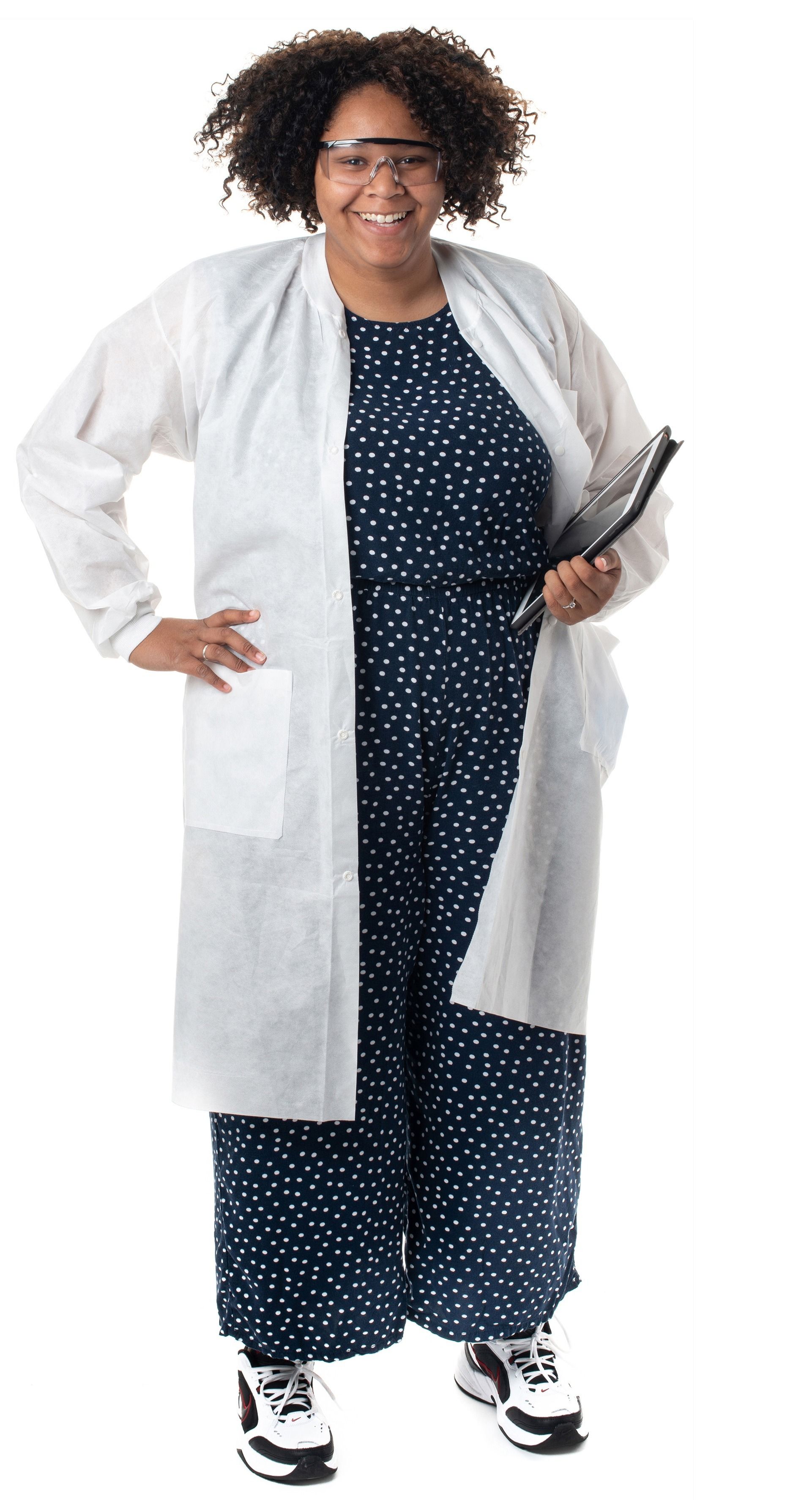 Undergraduate researcher Viola Munos wearing safety goggles and a lab coat, and holding an iPad.