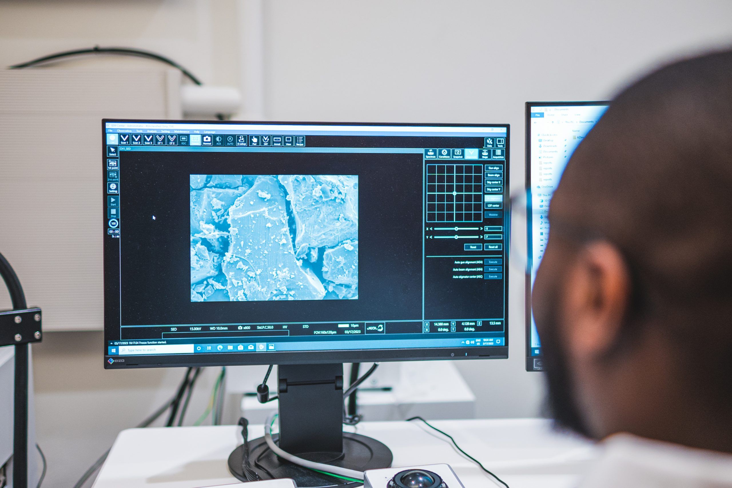 Rathnayake's student looking at nano microscopic data