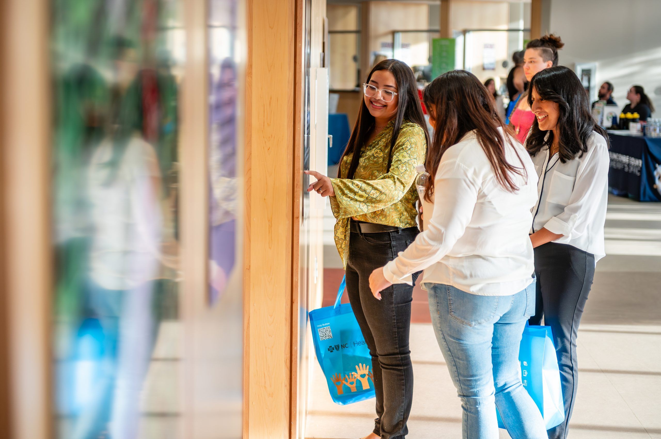 Teenagers exploring the photovoice exhibit