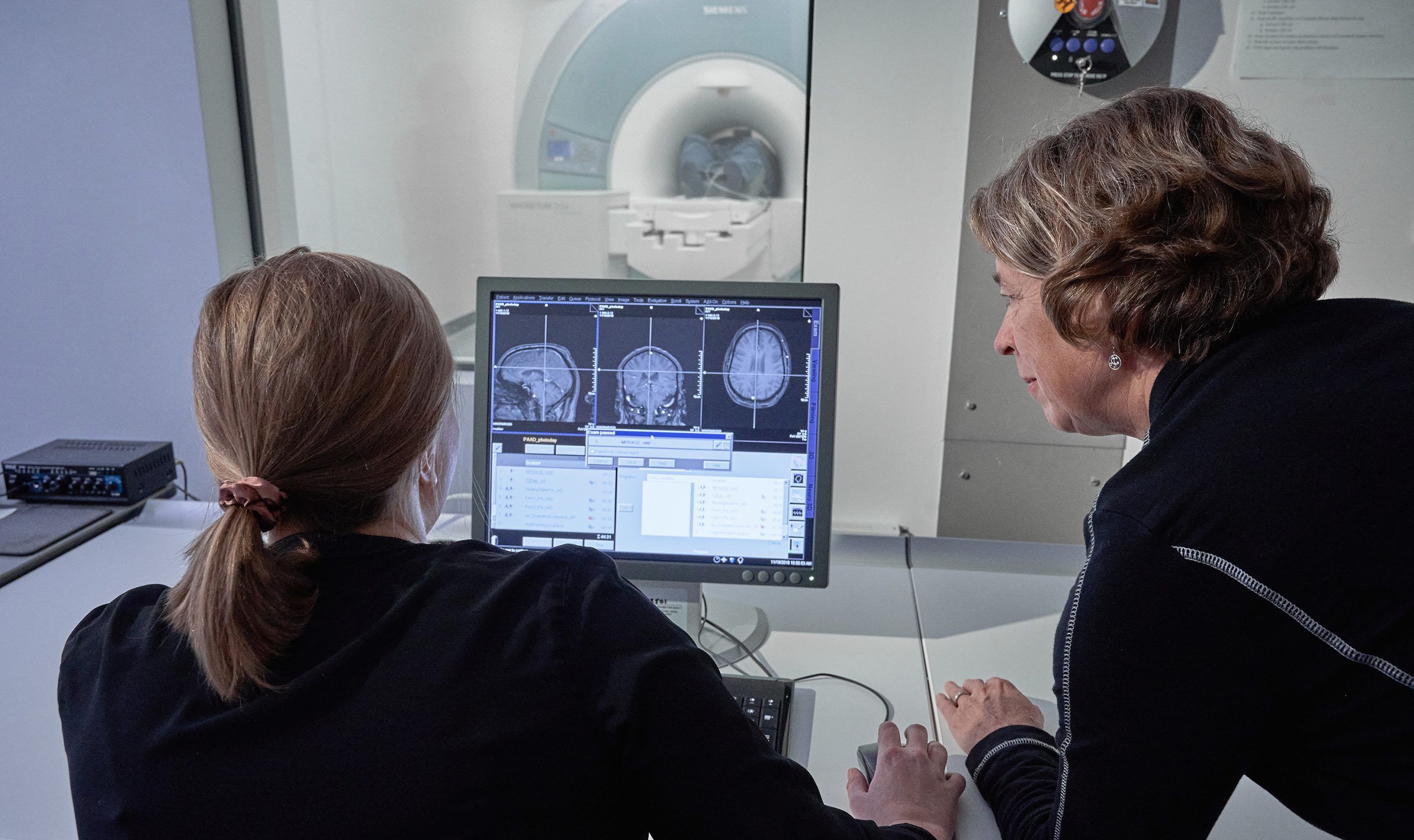 Etnier and a student looking at MRI results