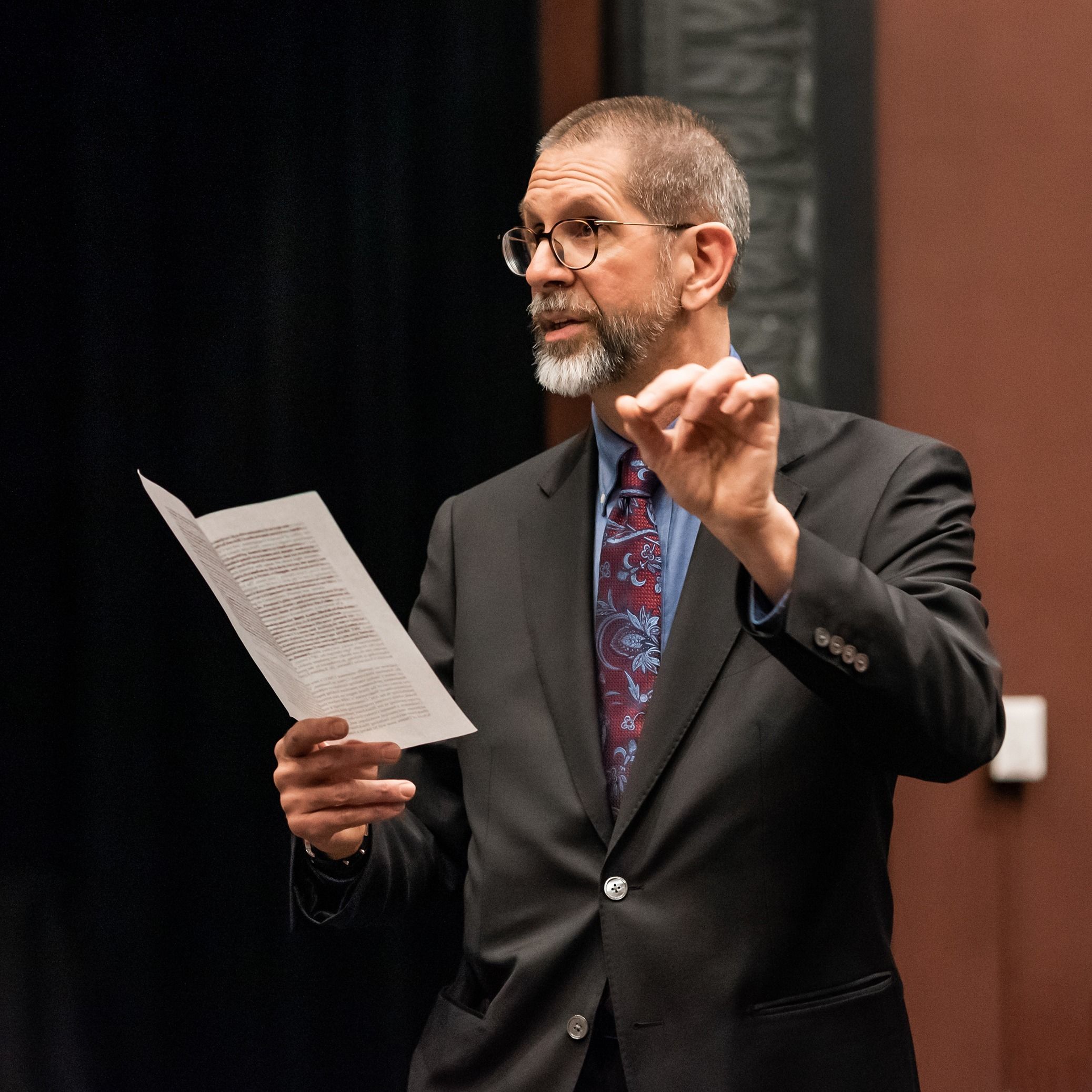 Hodgkins presents his work at an event.