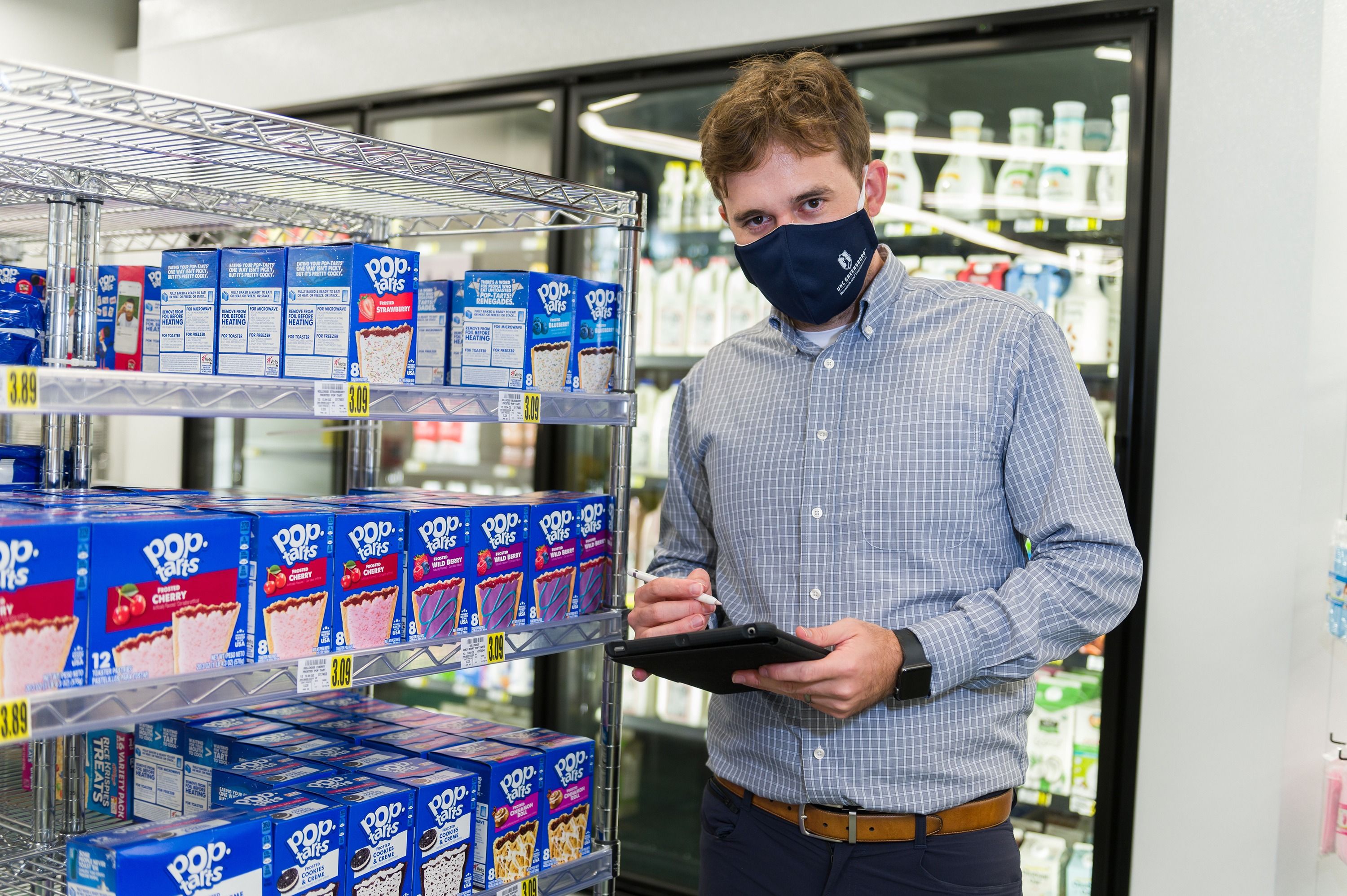 McGuirt standing next to several boxes of Poptarts