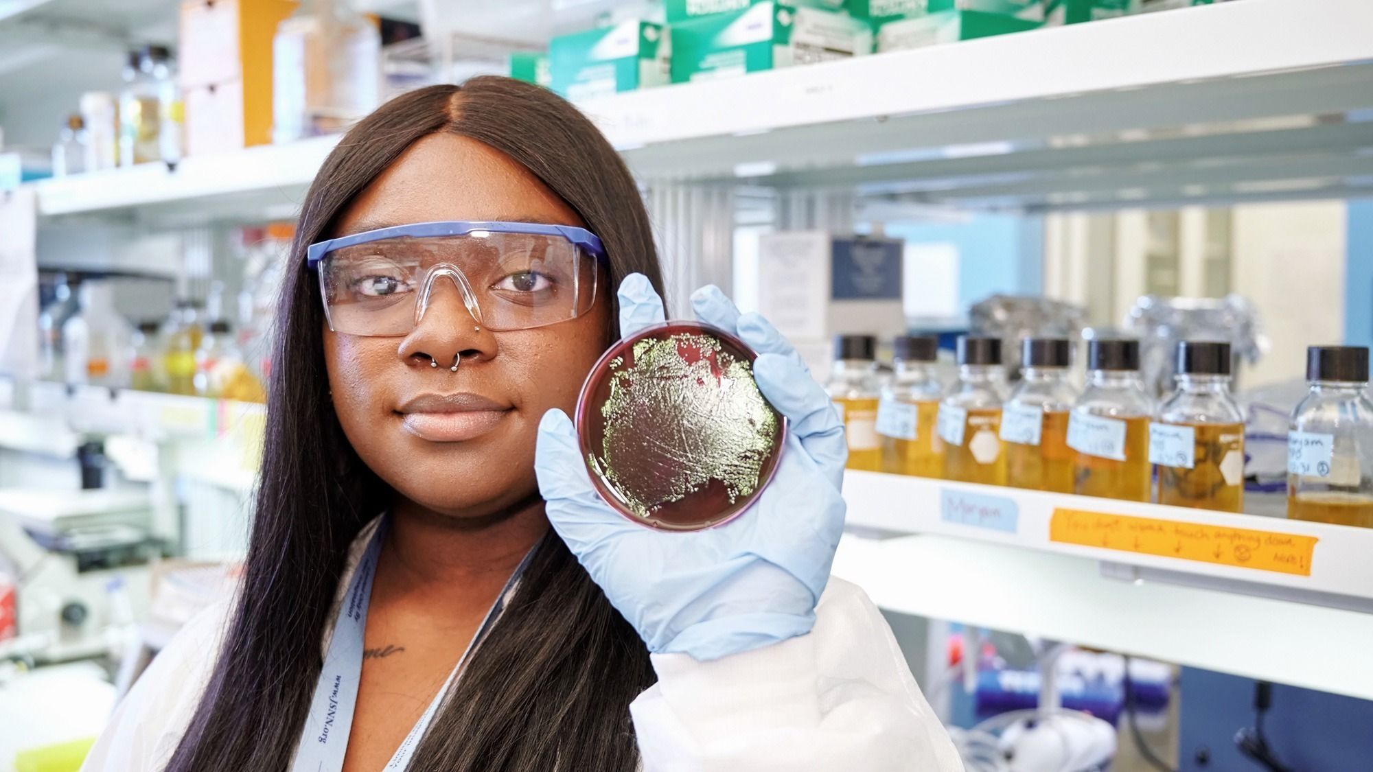 Marc U Star scholar holding up a petri dish