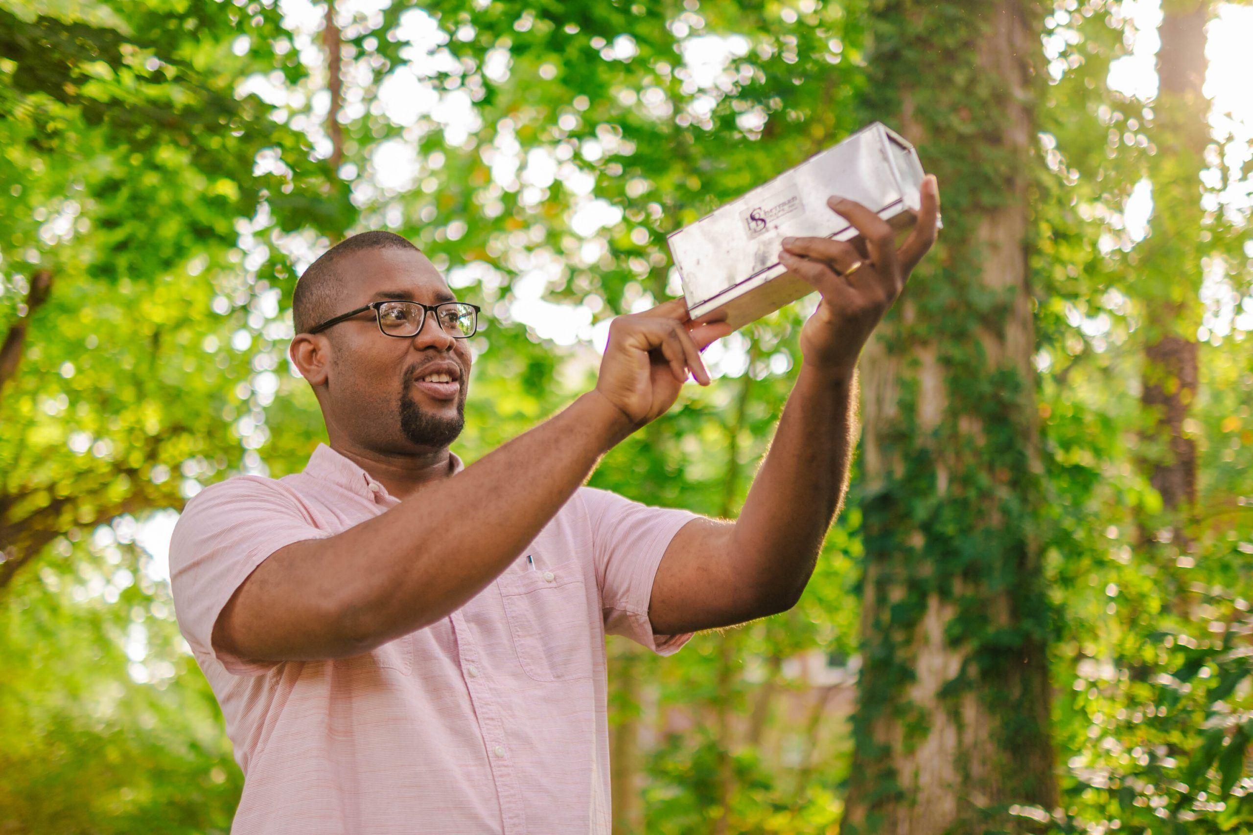 Noah Holland looking at an insect trap