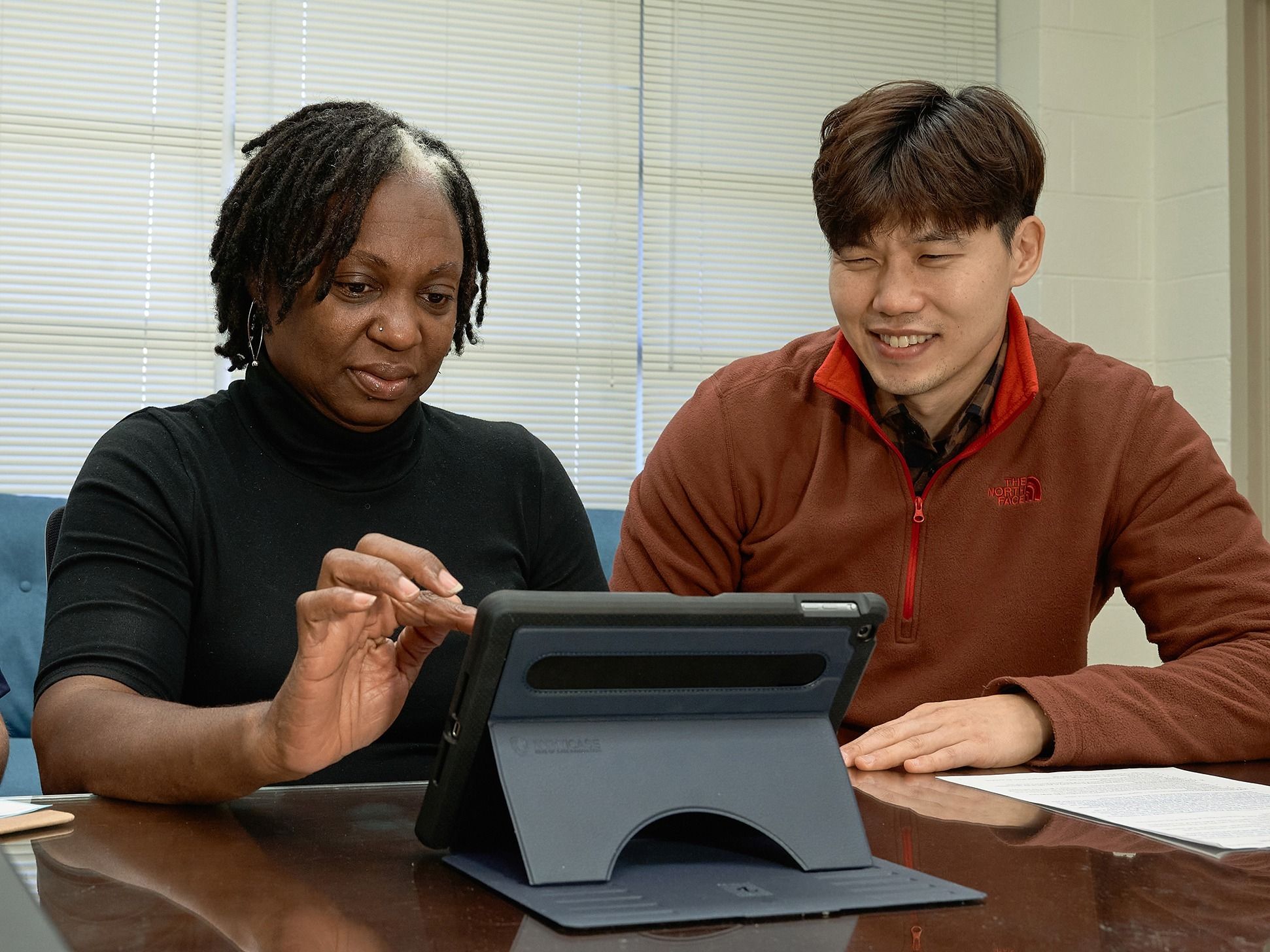 Postdoctoral fellow Kyoungshin Parks runs a staff member through one of the study's cognitive tests on an iPad.