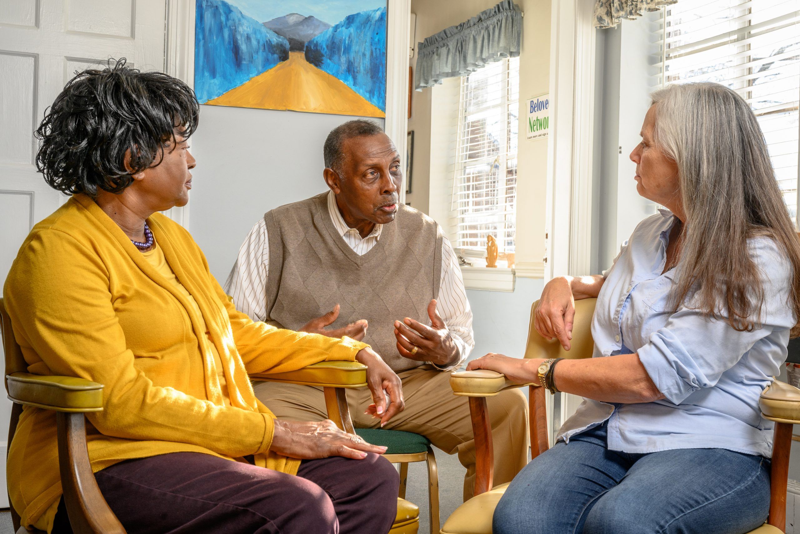 Community partners Joyce Johnson and Reverend Nelson Johnson speak with Dr. Spoma Jovanovic at the Beloved Community Center.
