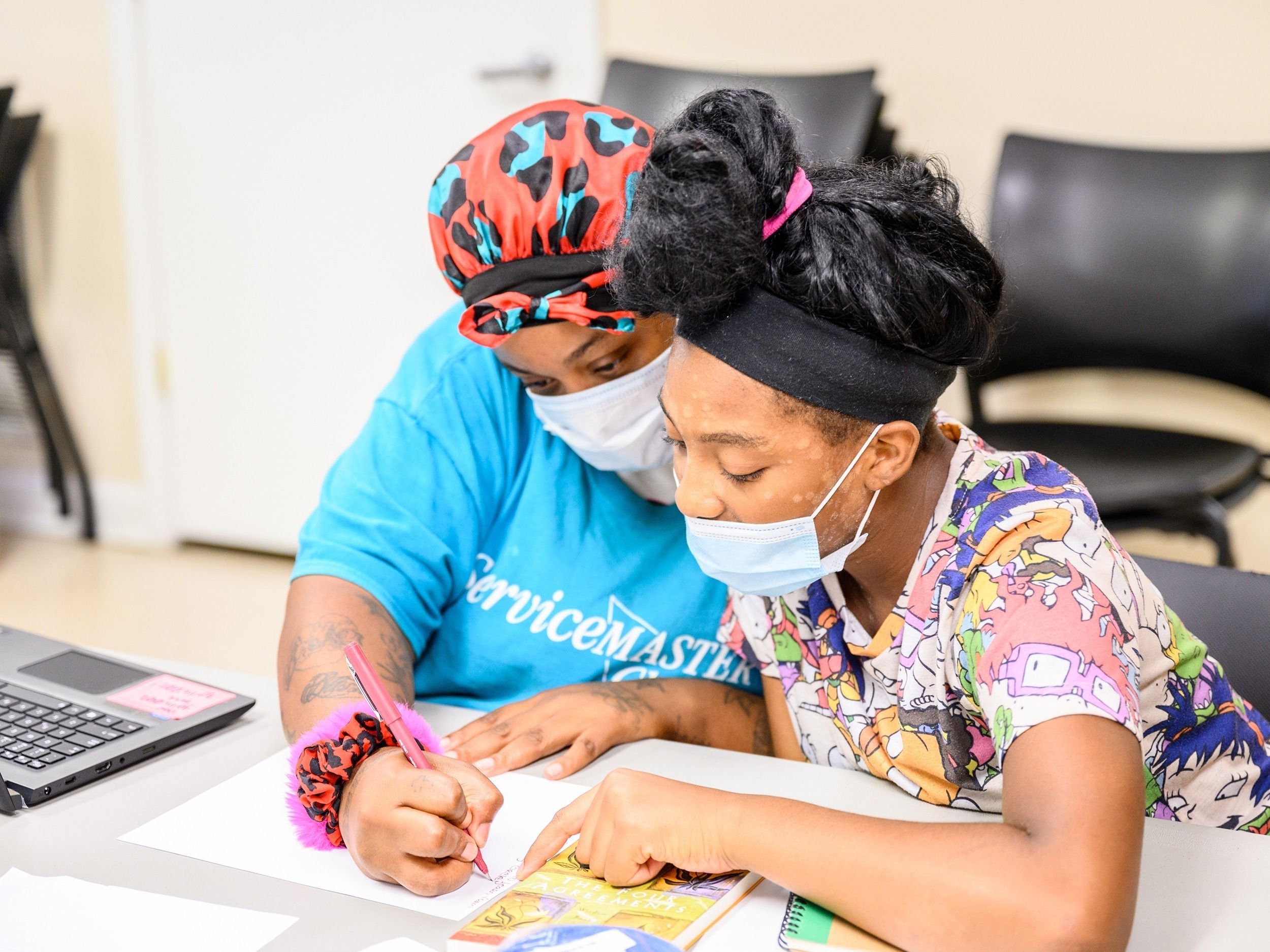 Two learning circles participants discuss notes.