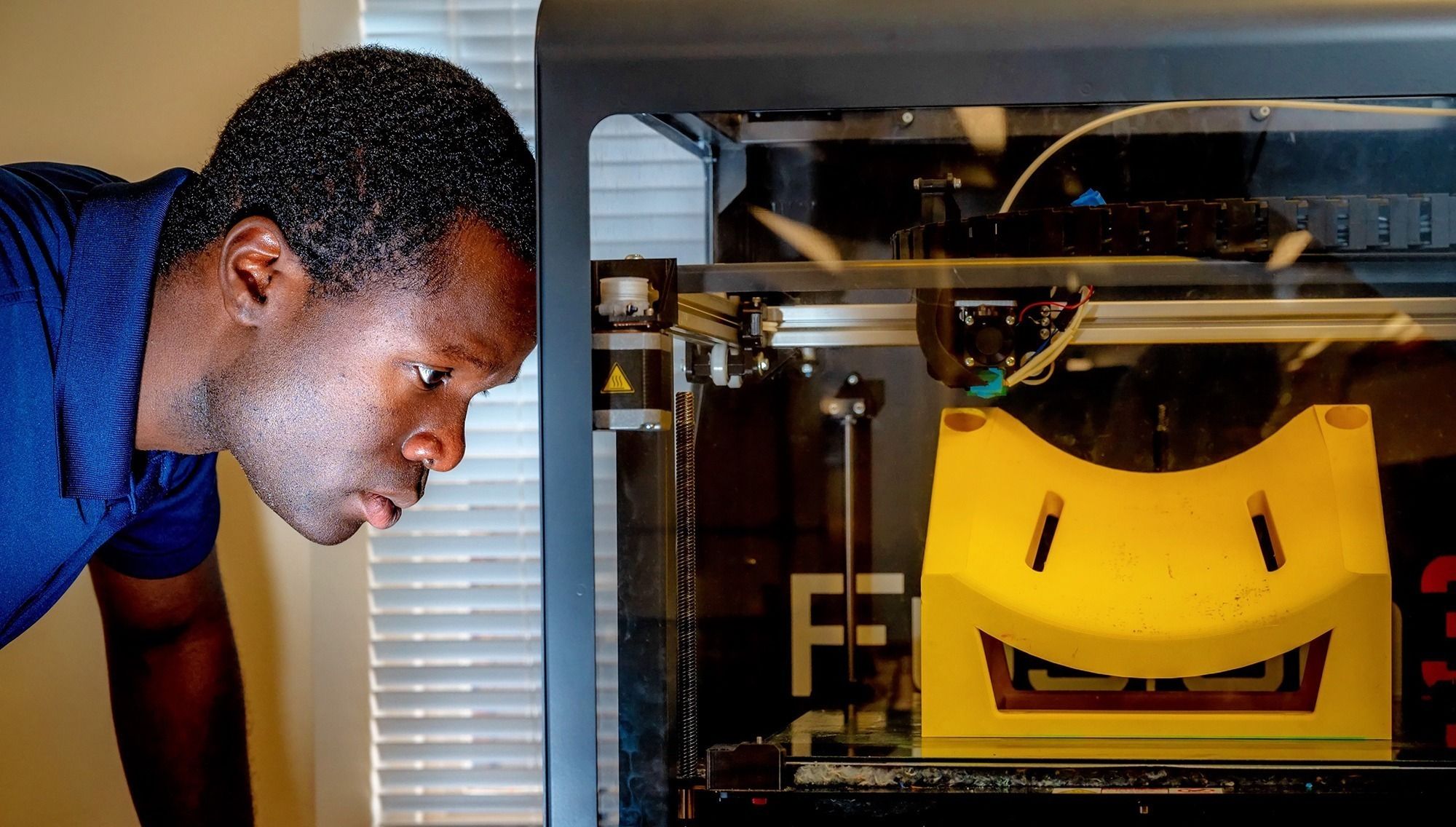 Student 3d printing a prototype