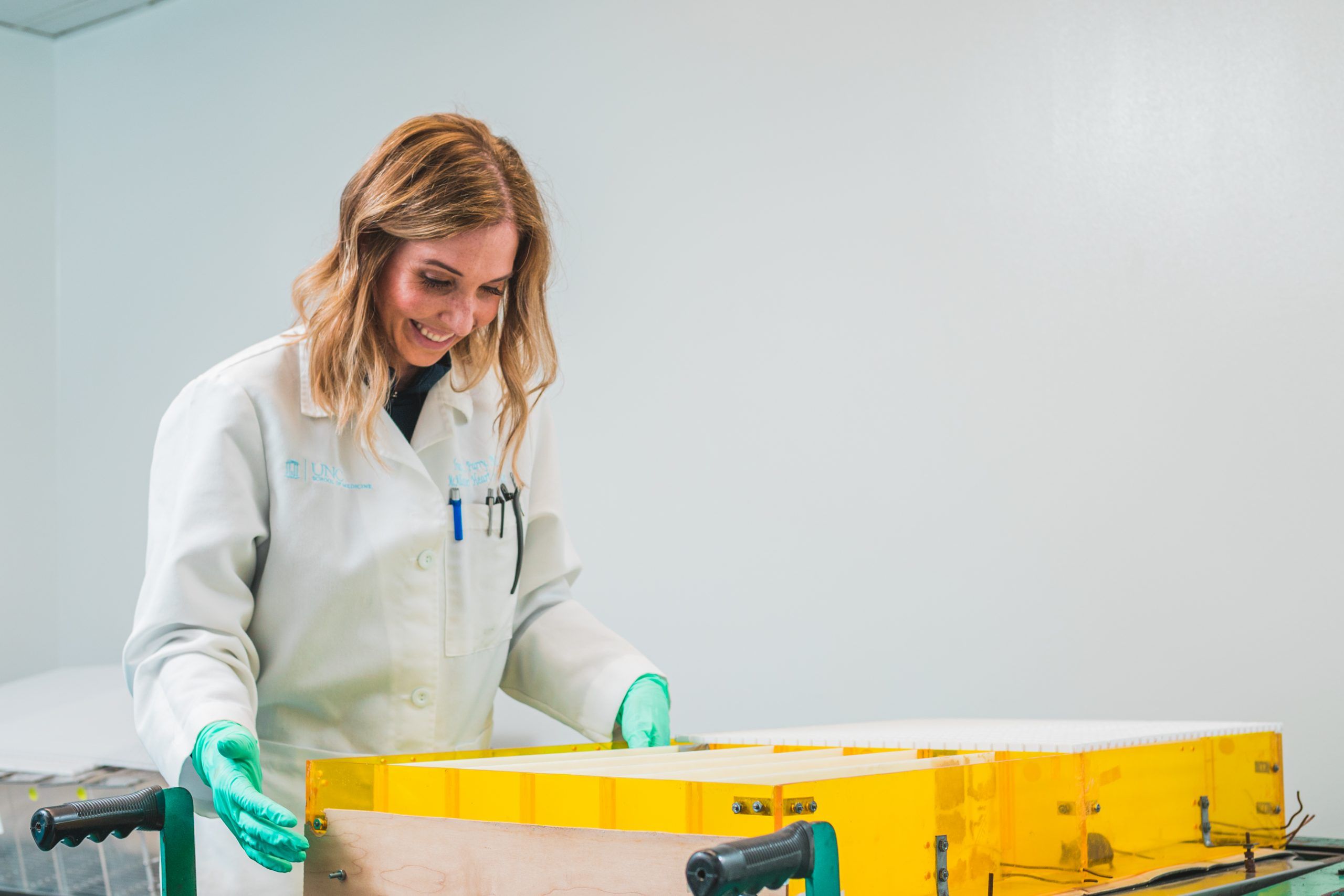 Dr. Traci Parry observing a mouse running through a maze.