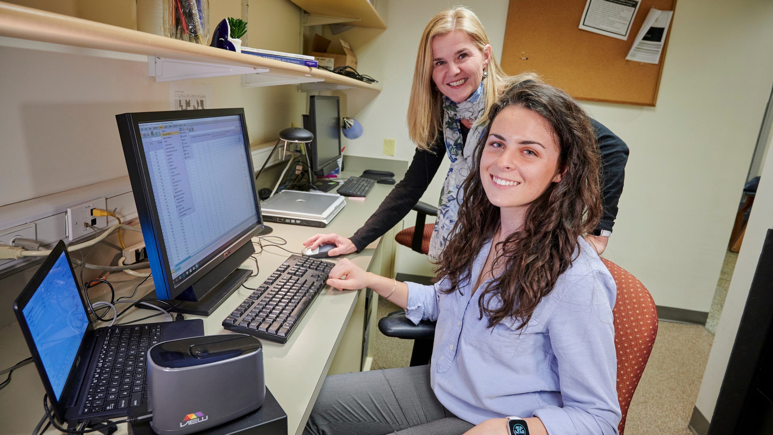 Two researchers at a computer 