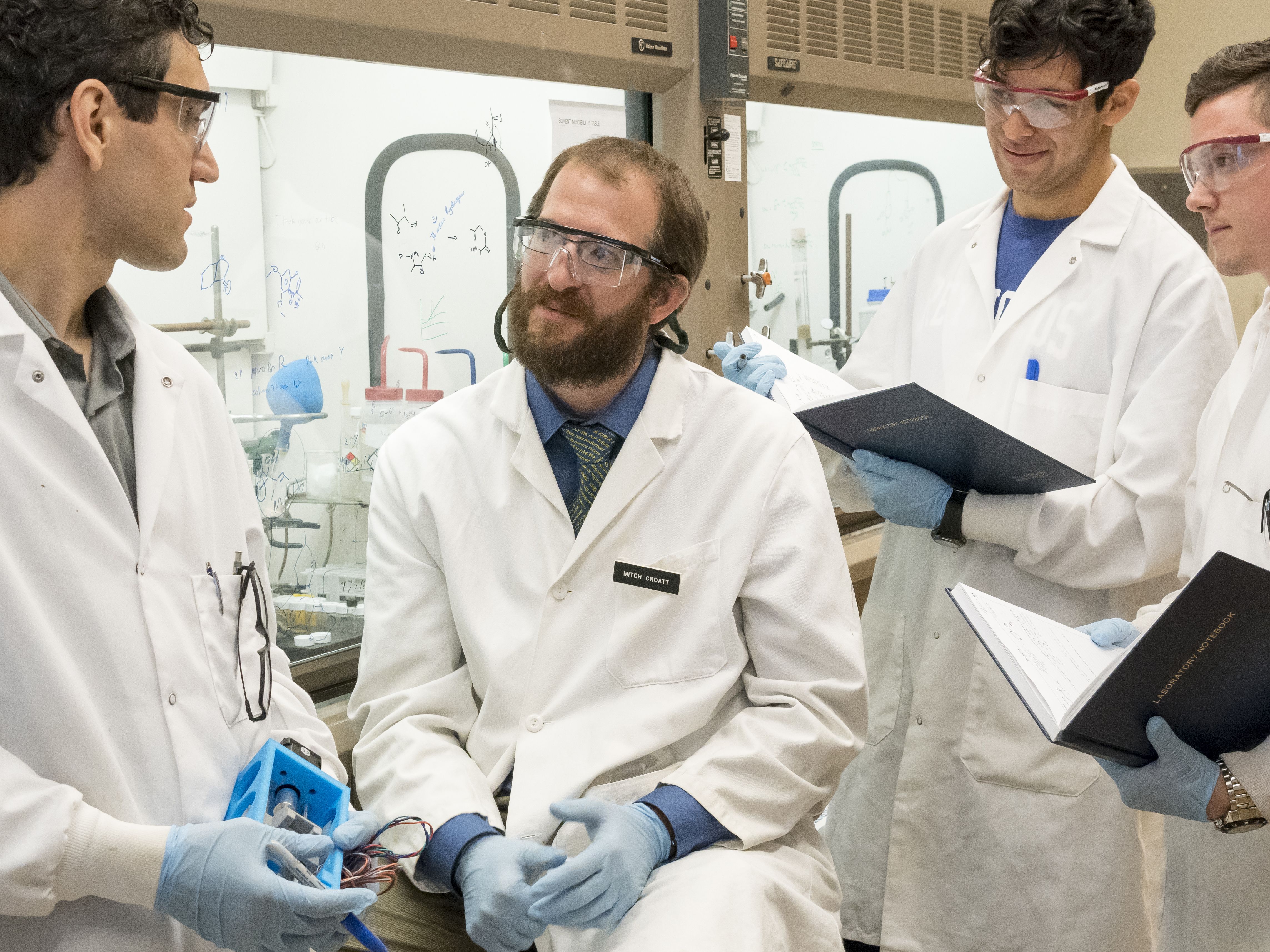 Researchers in a lab discussing results