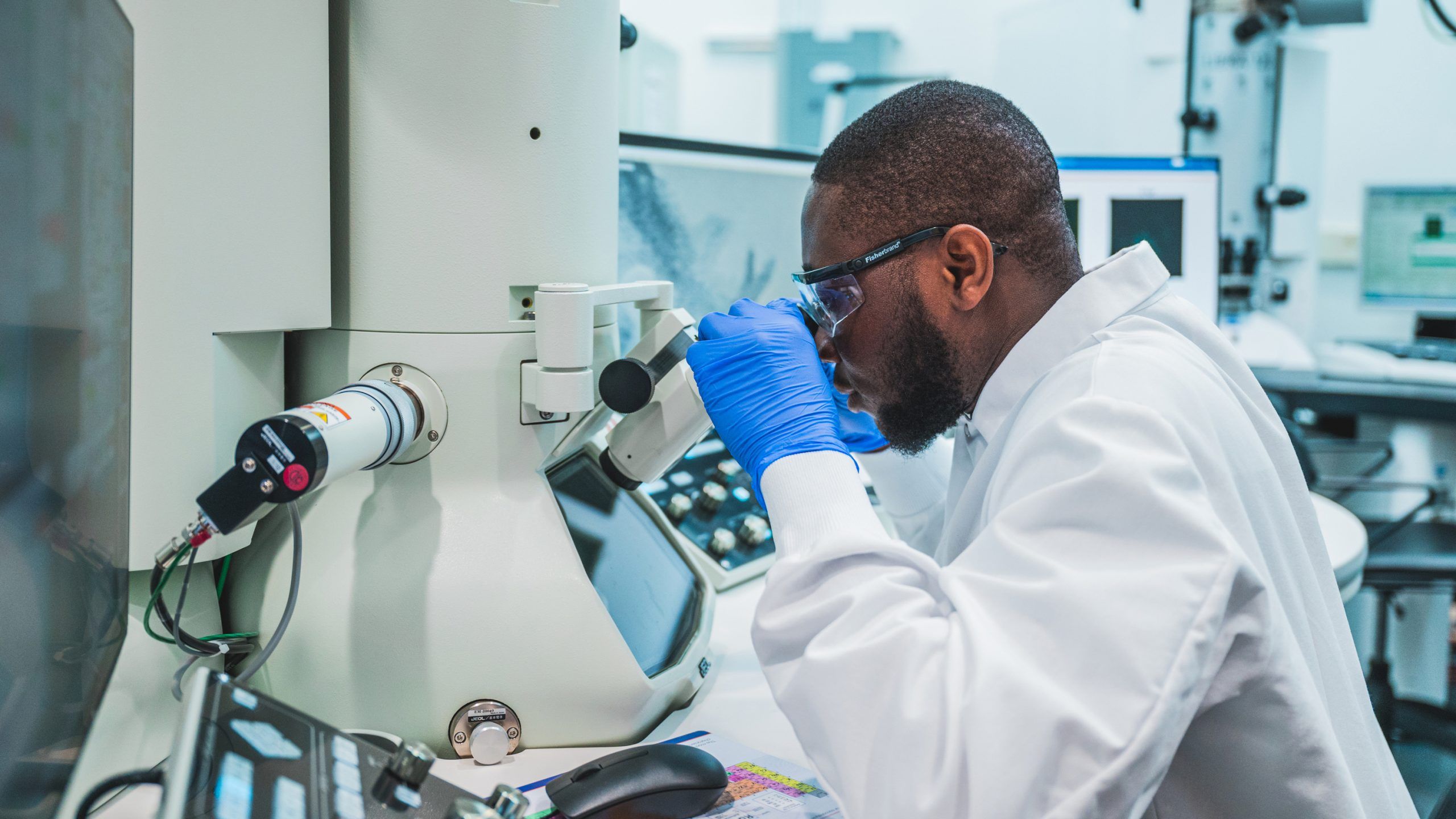 Kevin Adrah using a microscope