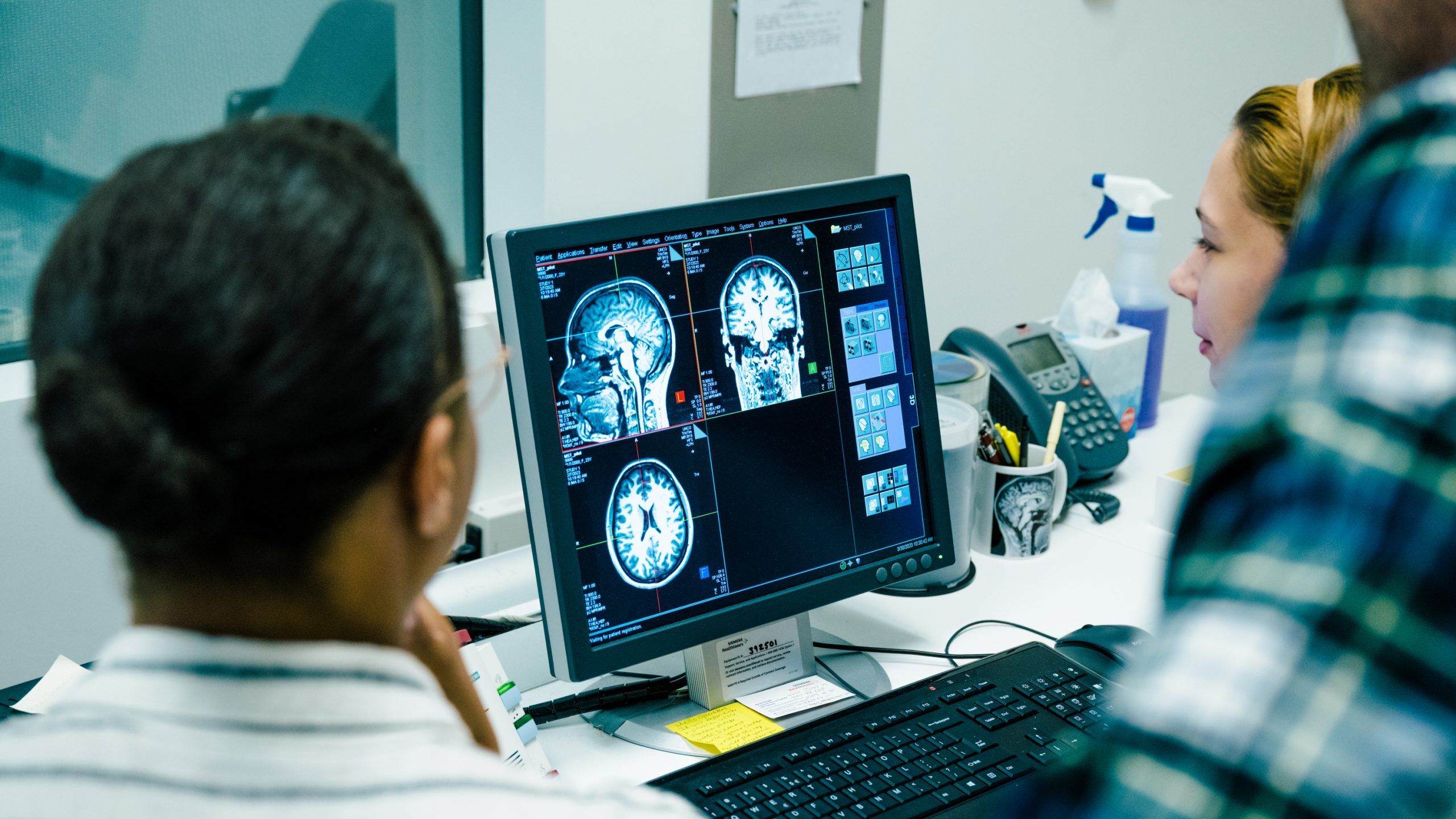 Students and professor reading the findings of a brain MRI